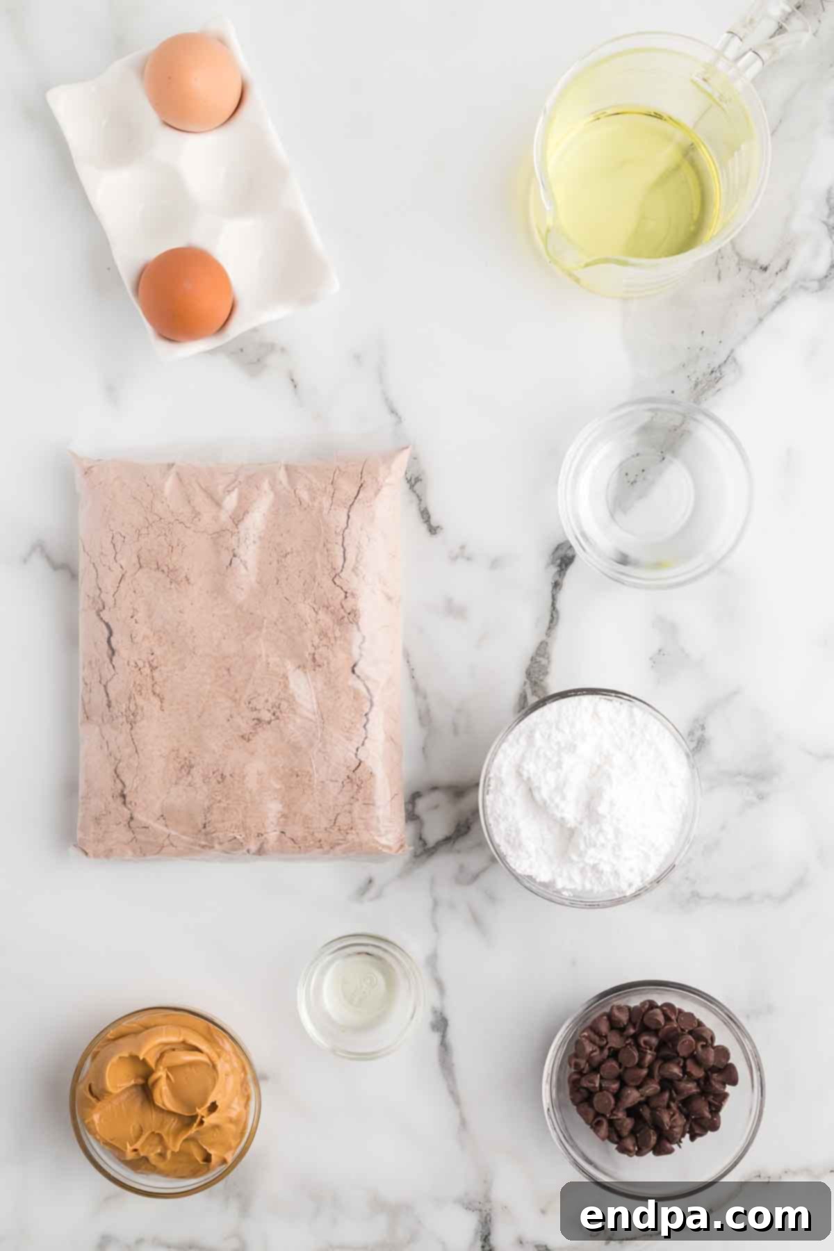 Peanut Butter Brownie Bliss Bites 3 Ingredients for Buckeye brownie bites: brownie mix, eggs, powdered sugar, creamy peanut butter, semi-sweet chocolate chips, and oil.