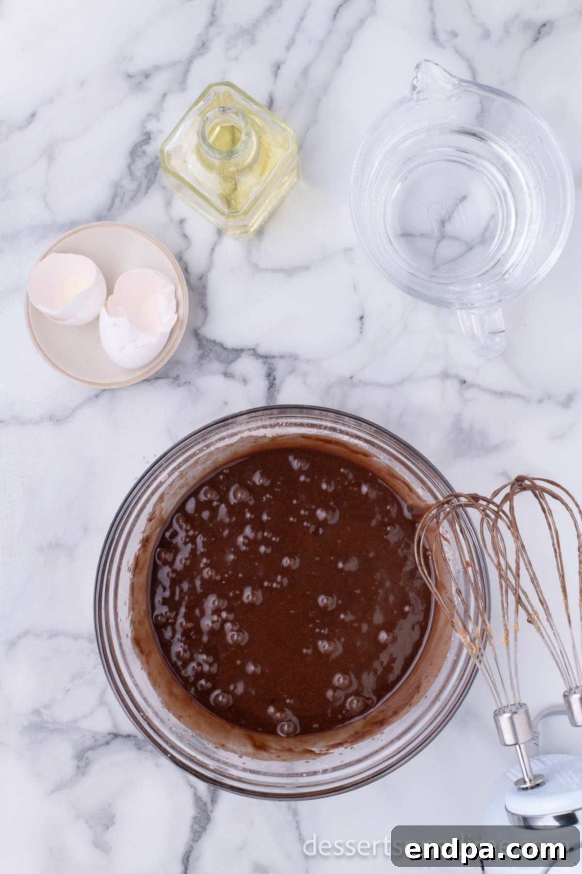 Peanut Butter Brownie Bliss Bites 6 Brownie mix combined with wet ingredients in a mixing bowl, ready for baking.