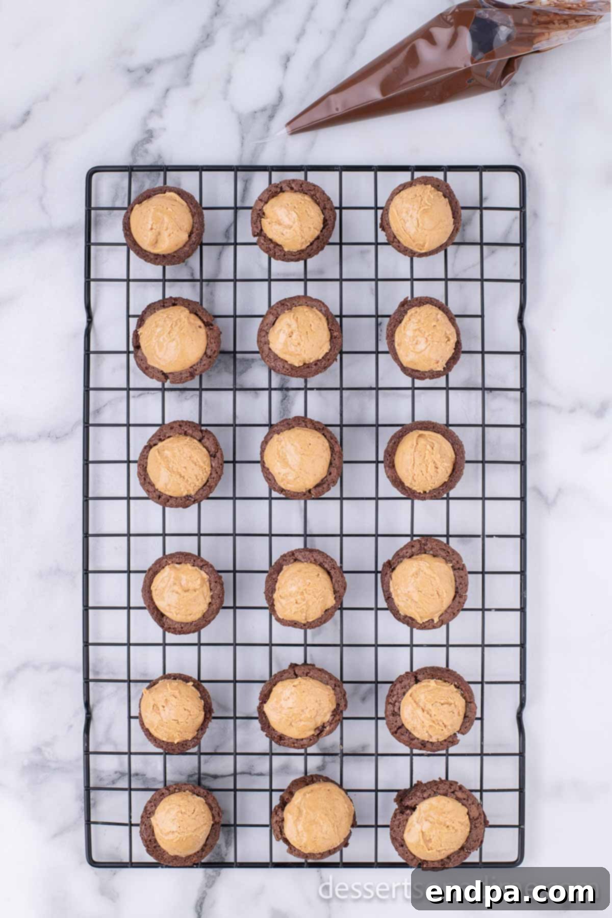 Peanut Butter Brownie Bliss Bites 10 Warm brownie bites with peanut butter centers cooling on a wire rack.