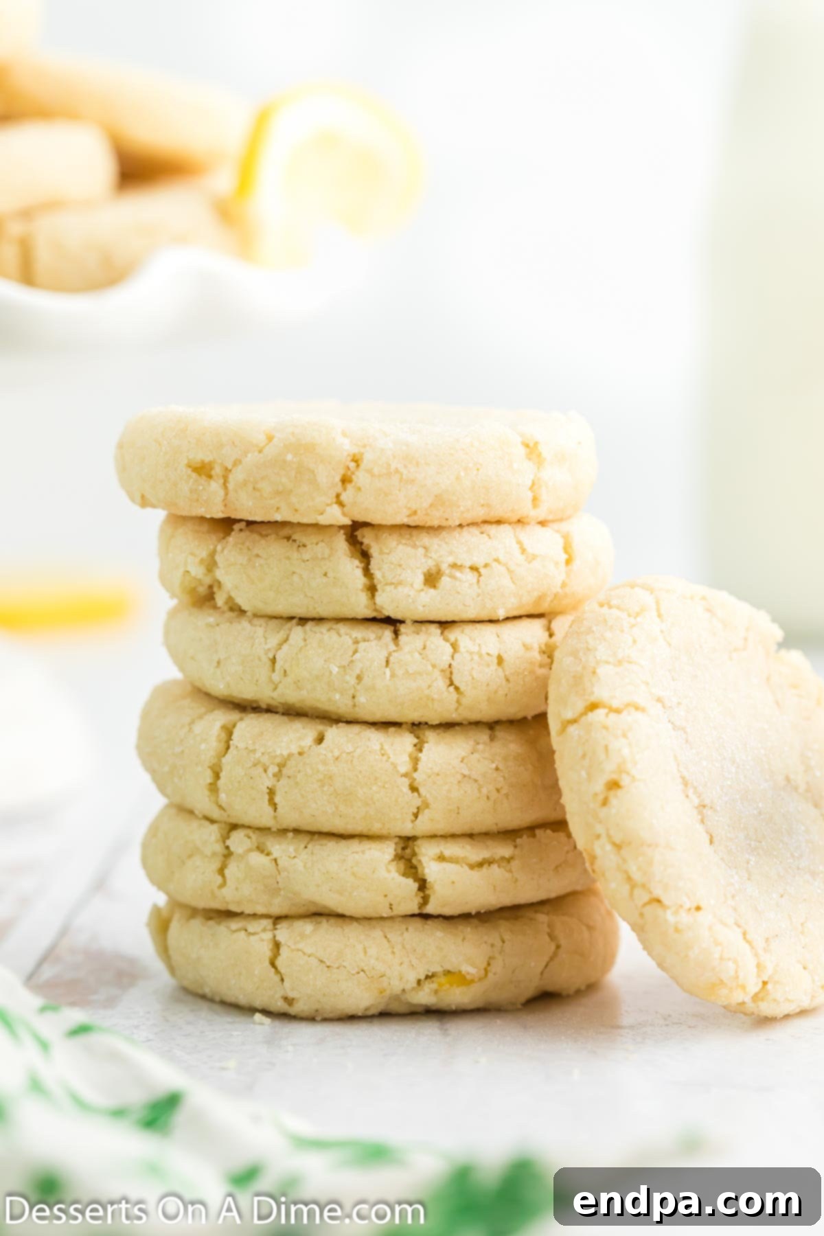 Stack of freshly baked Lemon Sugar Cookies, showcasing their soft texture and light golden edges.