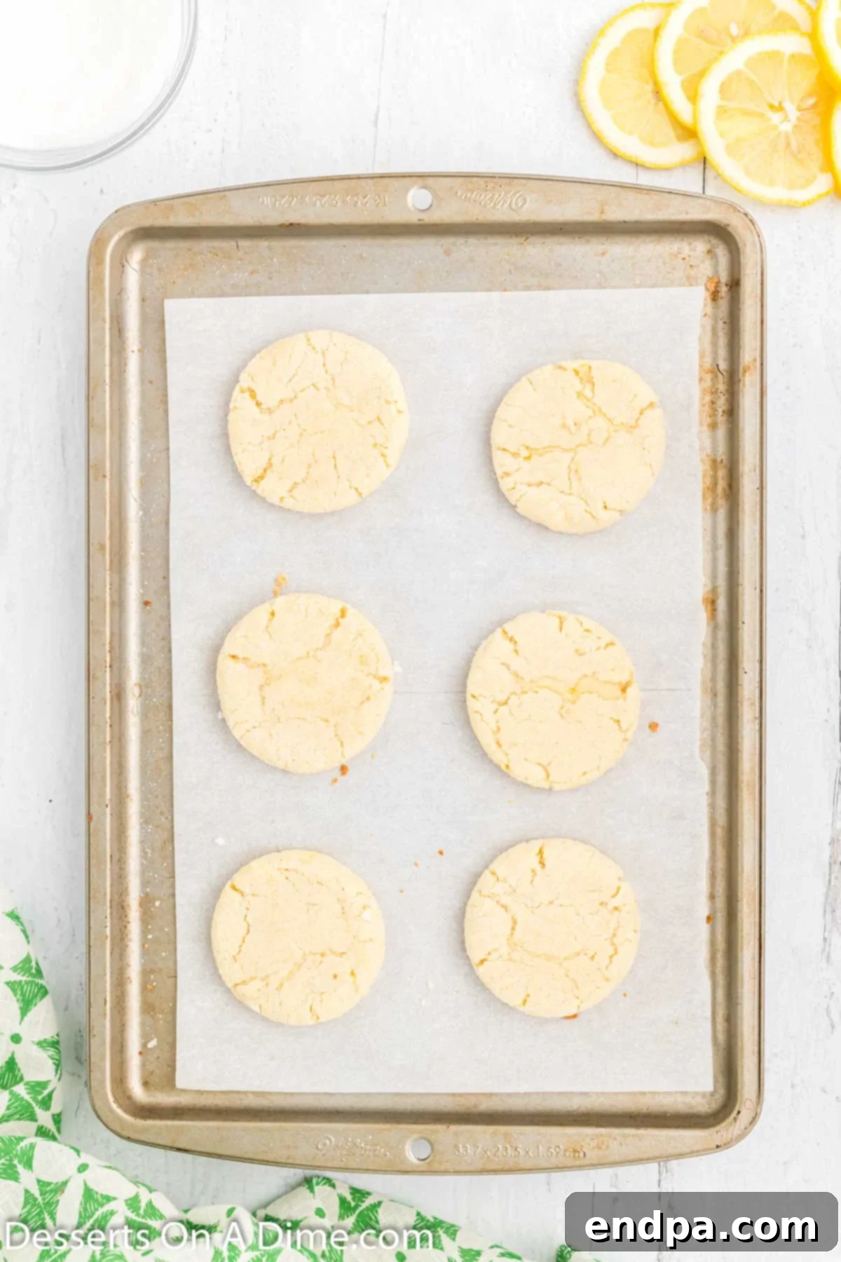 Freshly baked Lemon Sugar Cookies cooling on a wire rack after being removed from the oven.