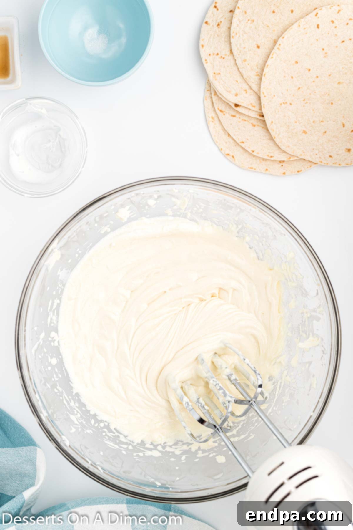 Crispy Cheesecake Chimis 5 Mixing bowl with sugar, vanilla extract, and sour cream added to the cream cheese mixture.