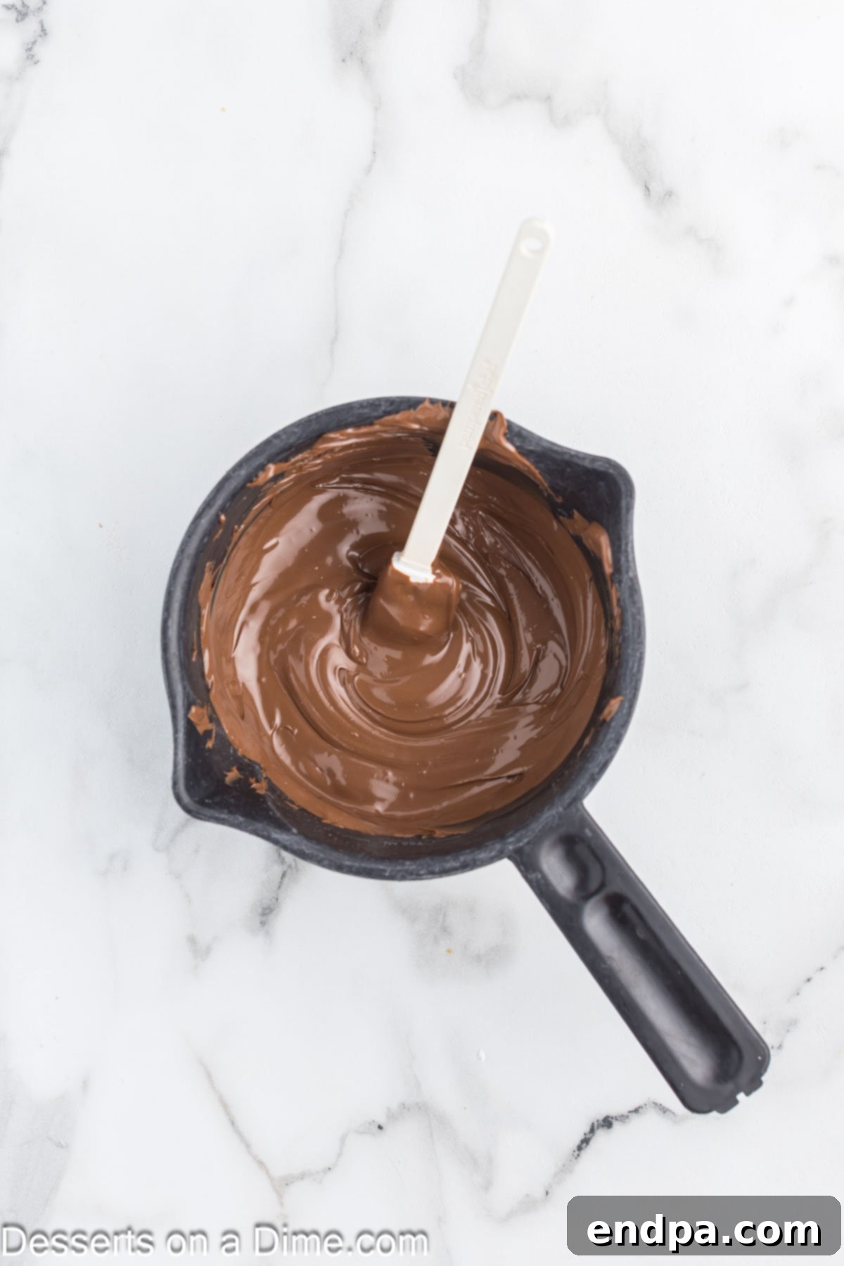 Decadent Hot Chocolate Puppy Chow 4 Melted chocolate in a microwave-safe bowl.