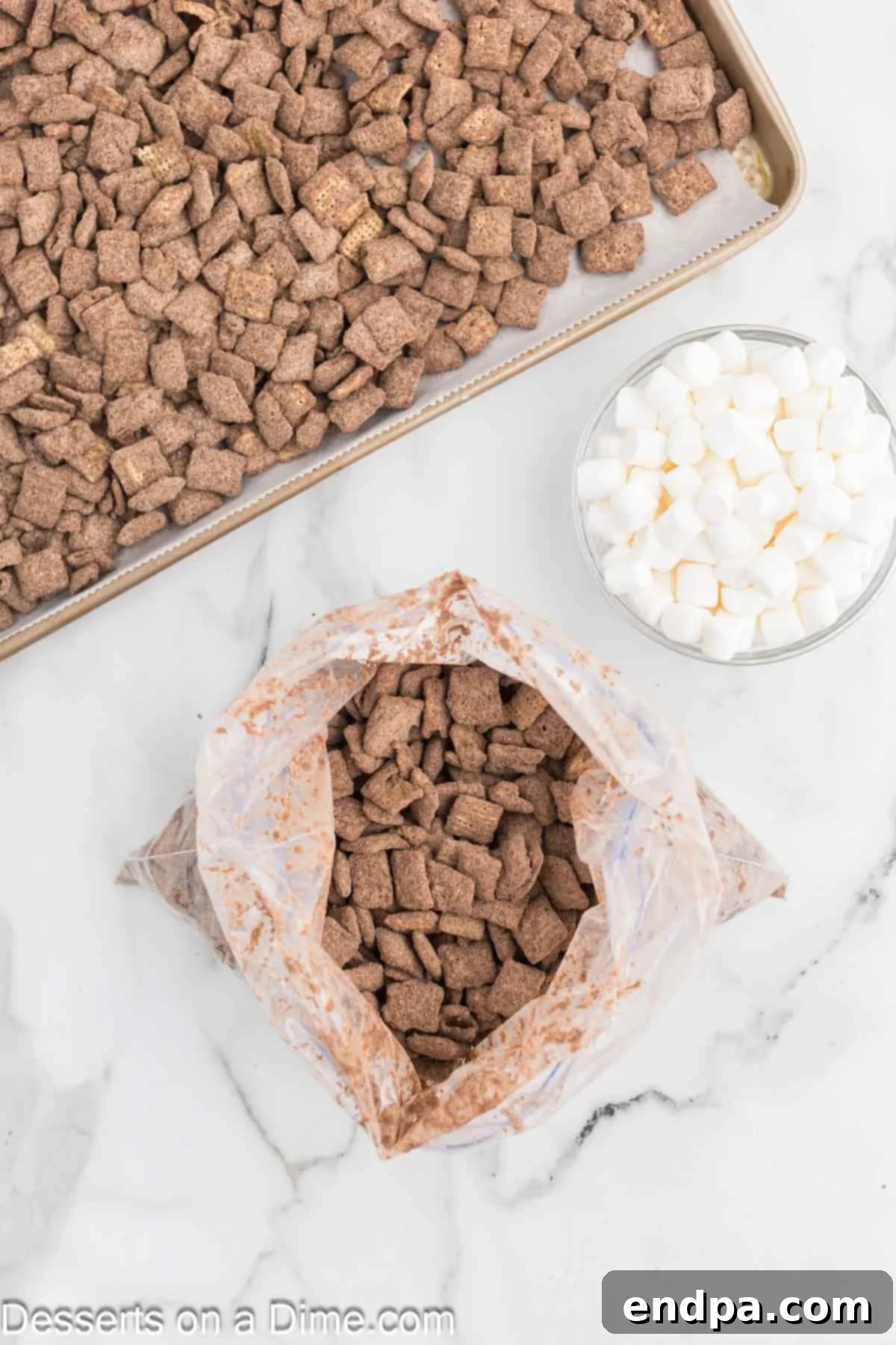 Decadent Hot Chocolate Puppy Chow 8 Chocolate-coated cereal being shaken with hot cocoa mix in a ziplock bag.