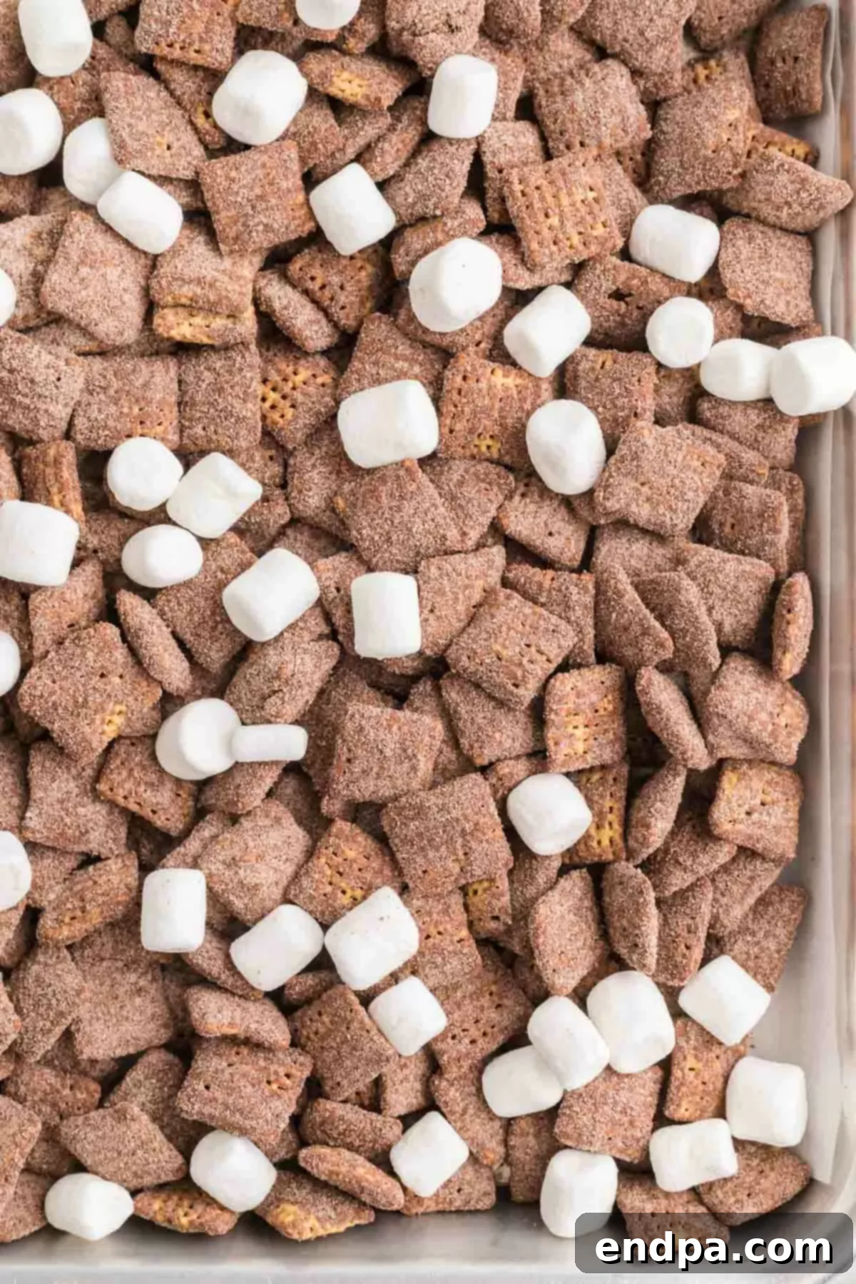 Decadent Hot Chocolate Puppy Chow 10 Baking sheet filled with hot chocolate puppy chow, ready to cool.