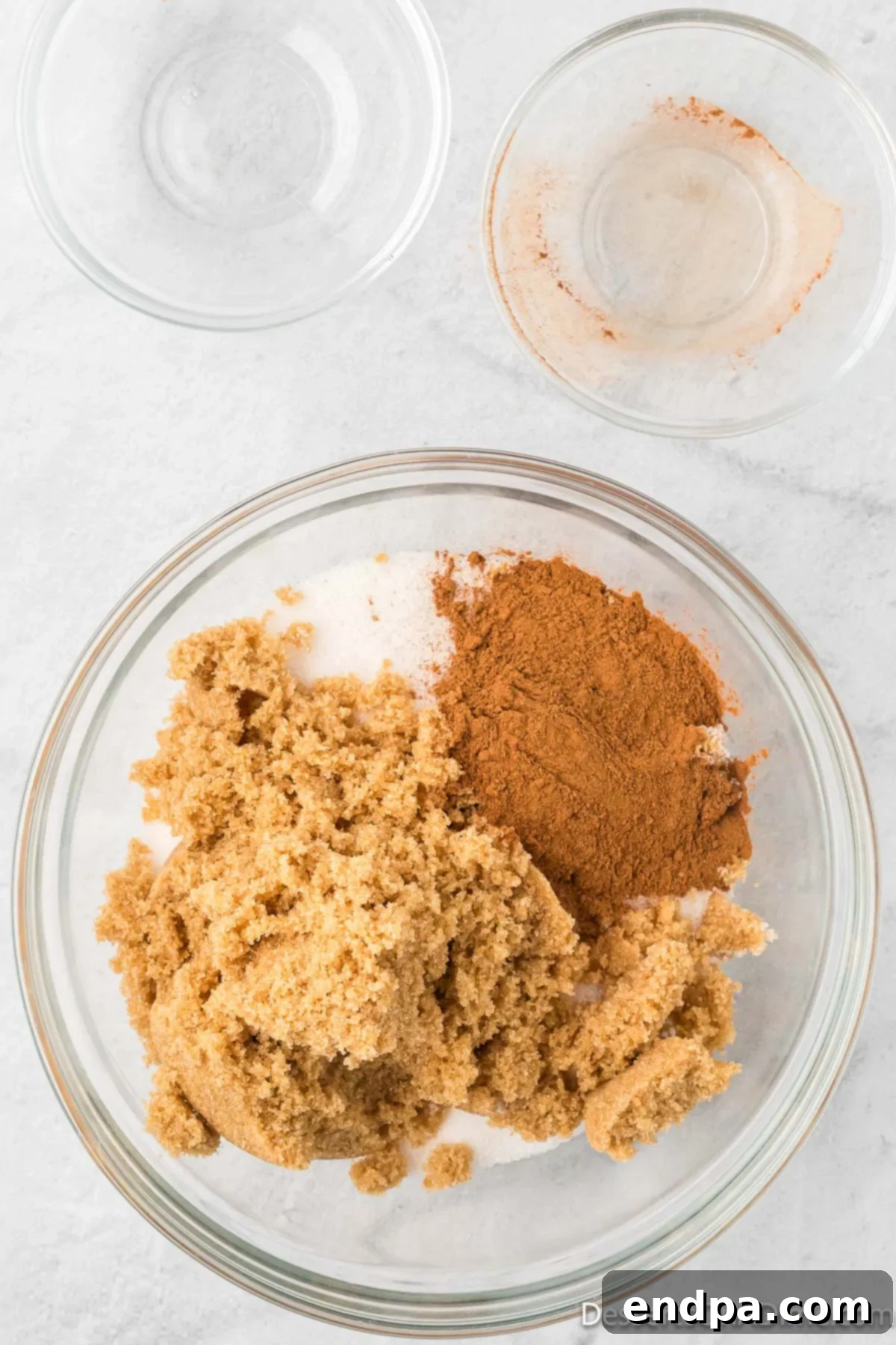 Mixing bowl with brown sugar, granulated sugar and cinnamon. 