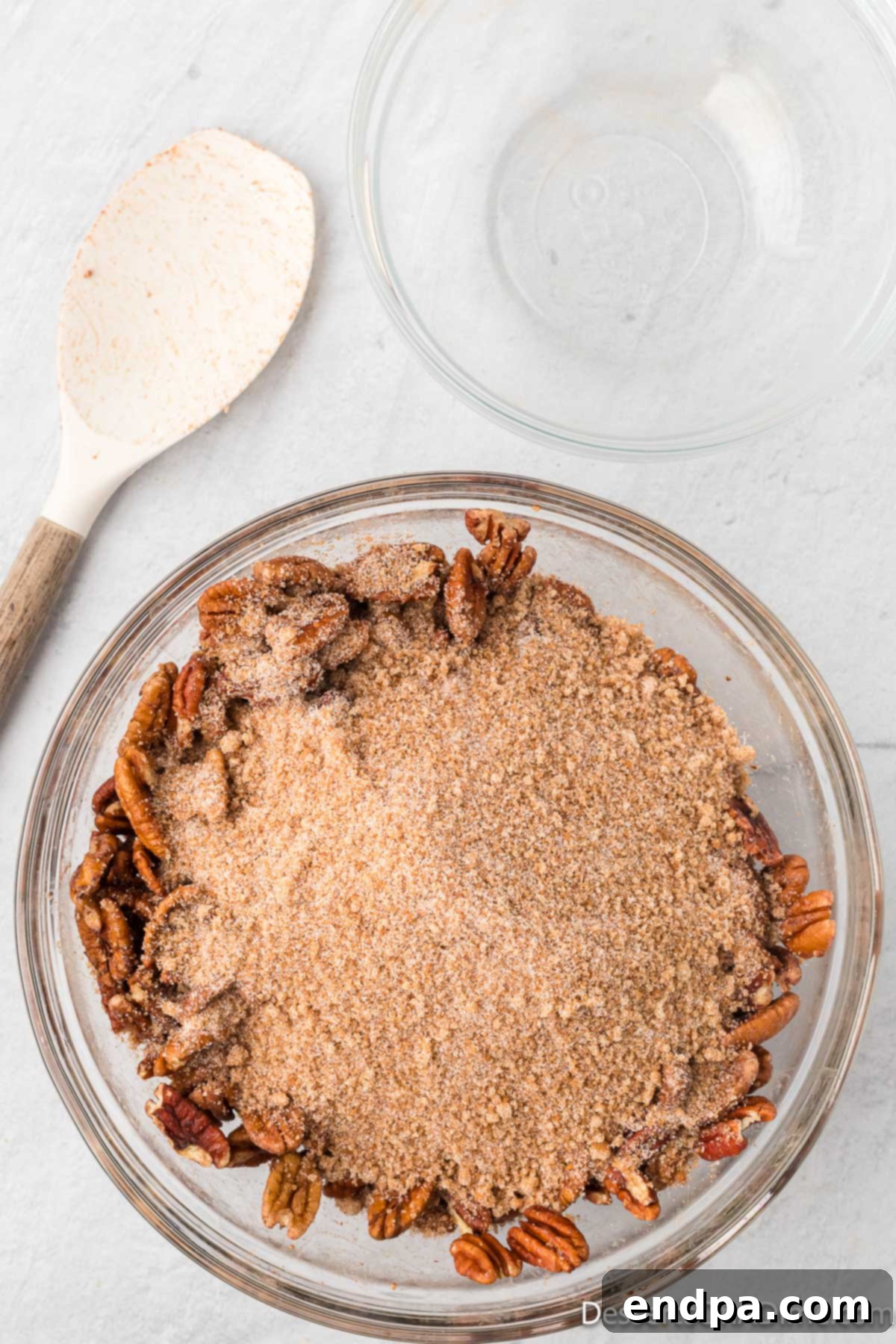 Cinnamon mixture poured over pecans. 