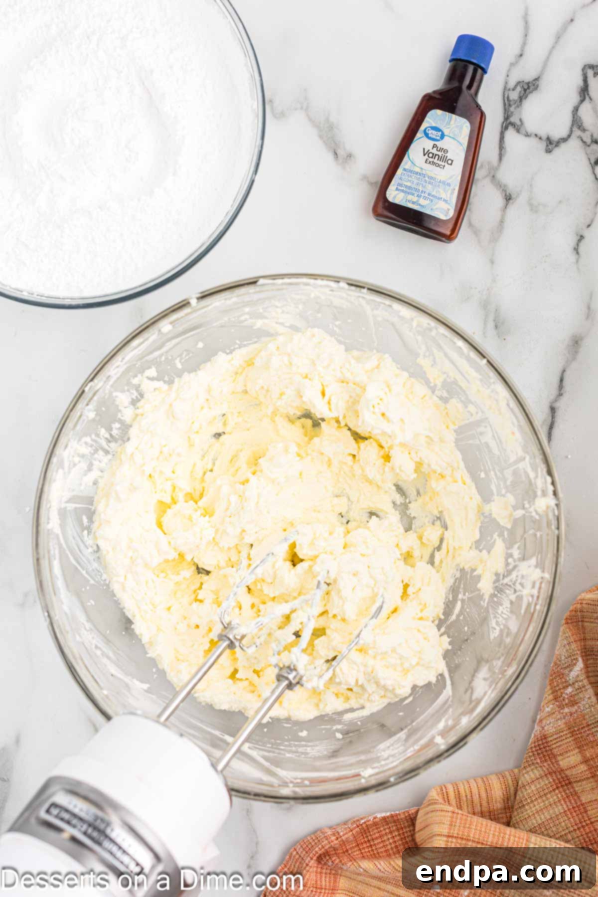 Ultimate Homemade Cream Cheese Frosting 4 Mixing bowl with butter and cream cheese.