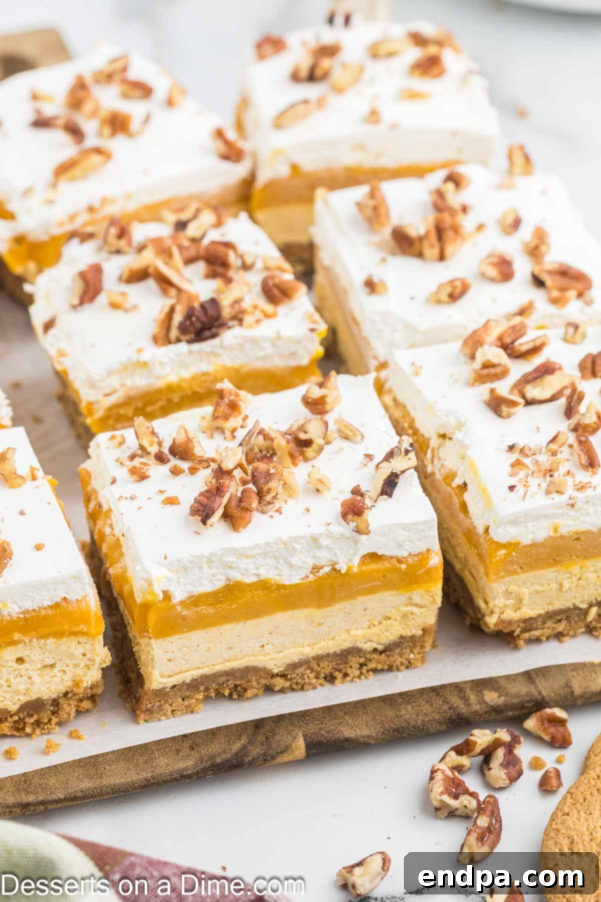 Spiced Pumpkin Cloud Bars 10 Pumpkin Dream Bars cut into bars on a serving plate.