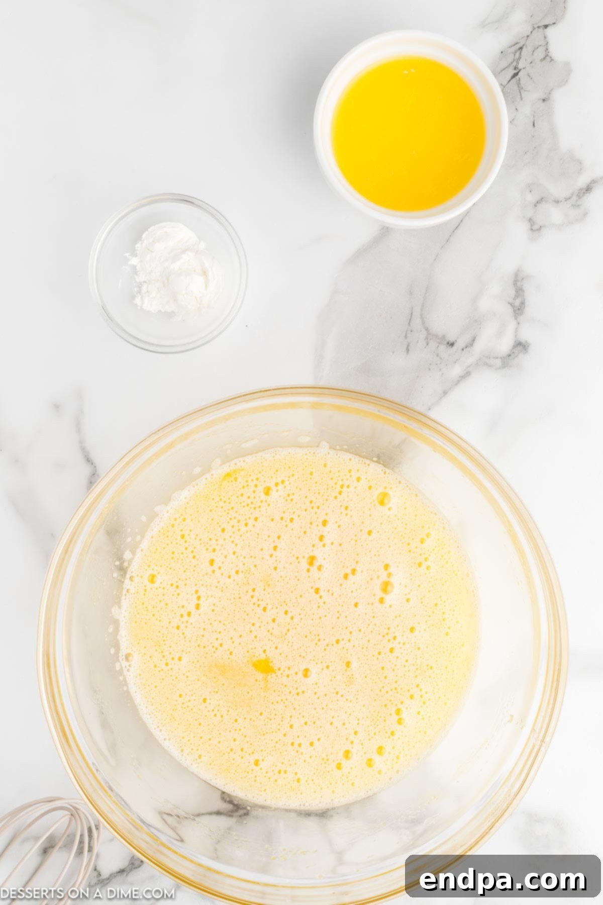 A smooth, amber-colored mixture of eggs, sugar, corn syrup, and melted butter, perfectly combined in a large mixing bowl, ready for the next steps.