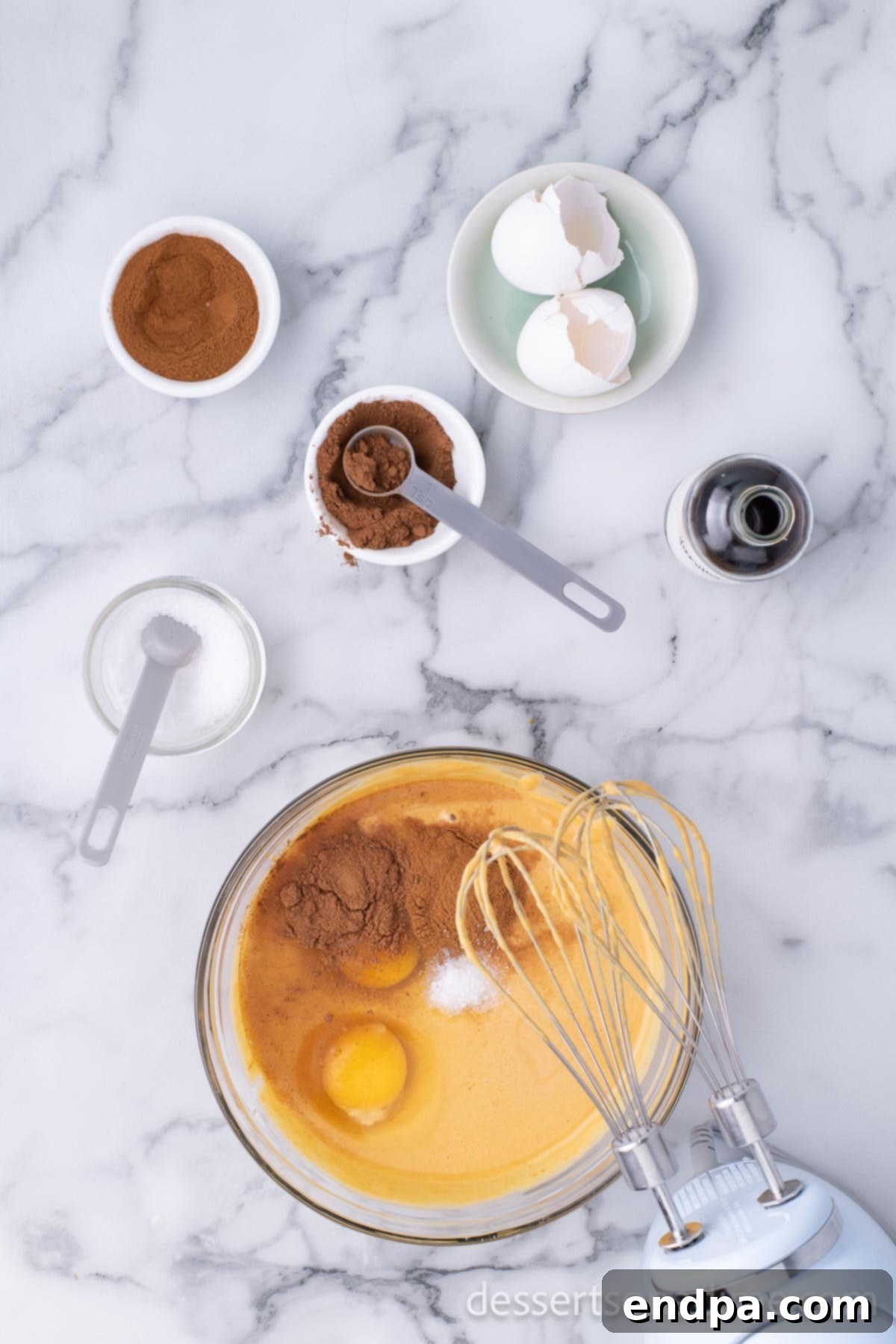 Luscious Dulce De Leche Pumpkin Pie 4 Combining all the pumpkin pie ingredients in a large mixing bowl with a hand mixer, showing the creamy texture of the filling.