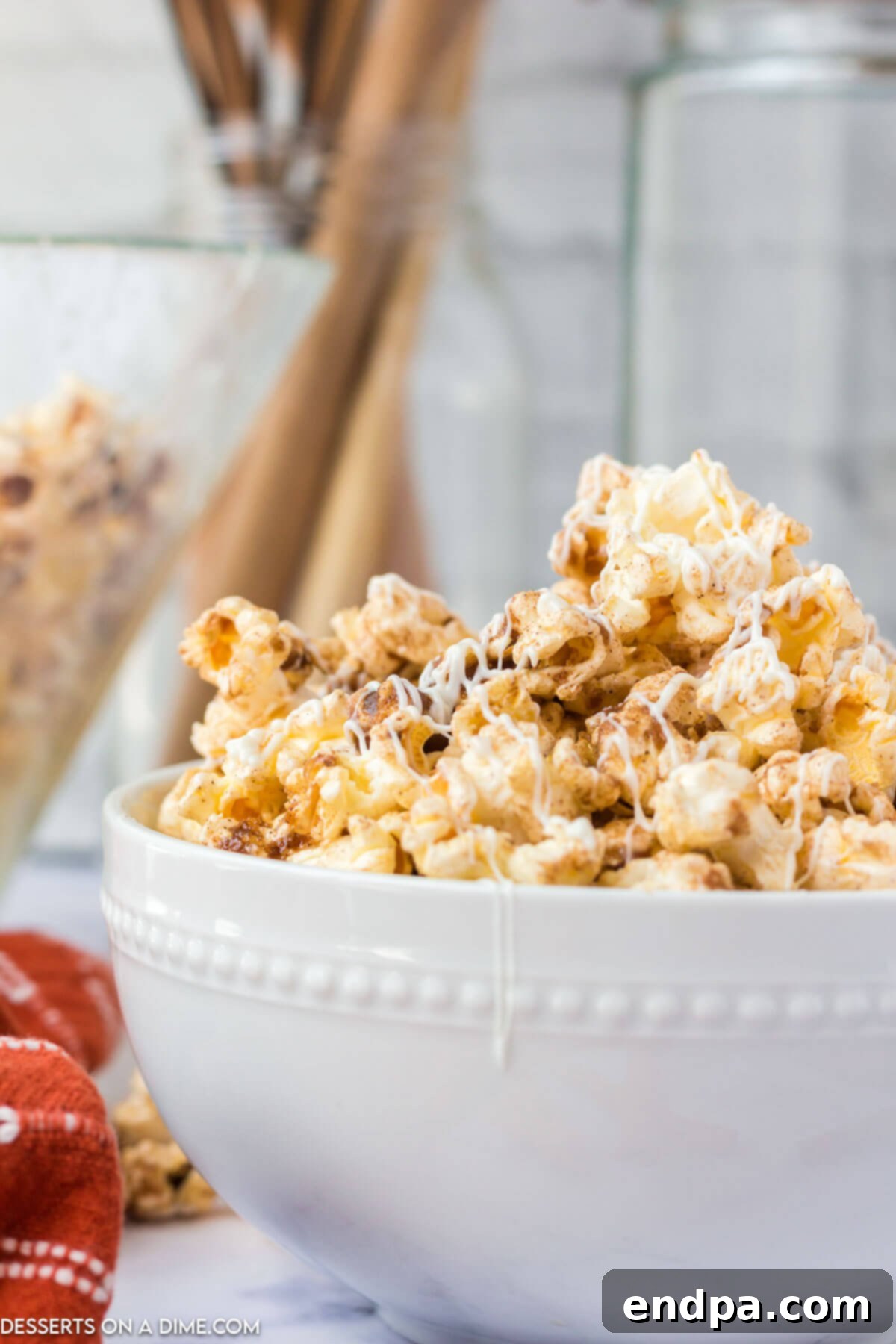 Frosted Cinnamon Popcorn 2 Cinnamon roll popcorn in a bowl.