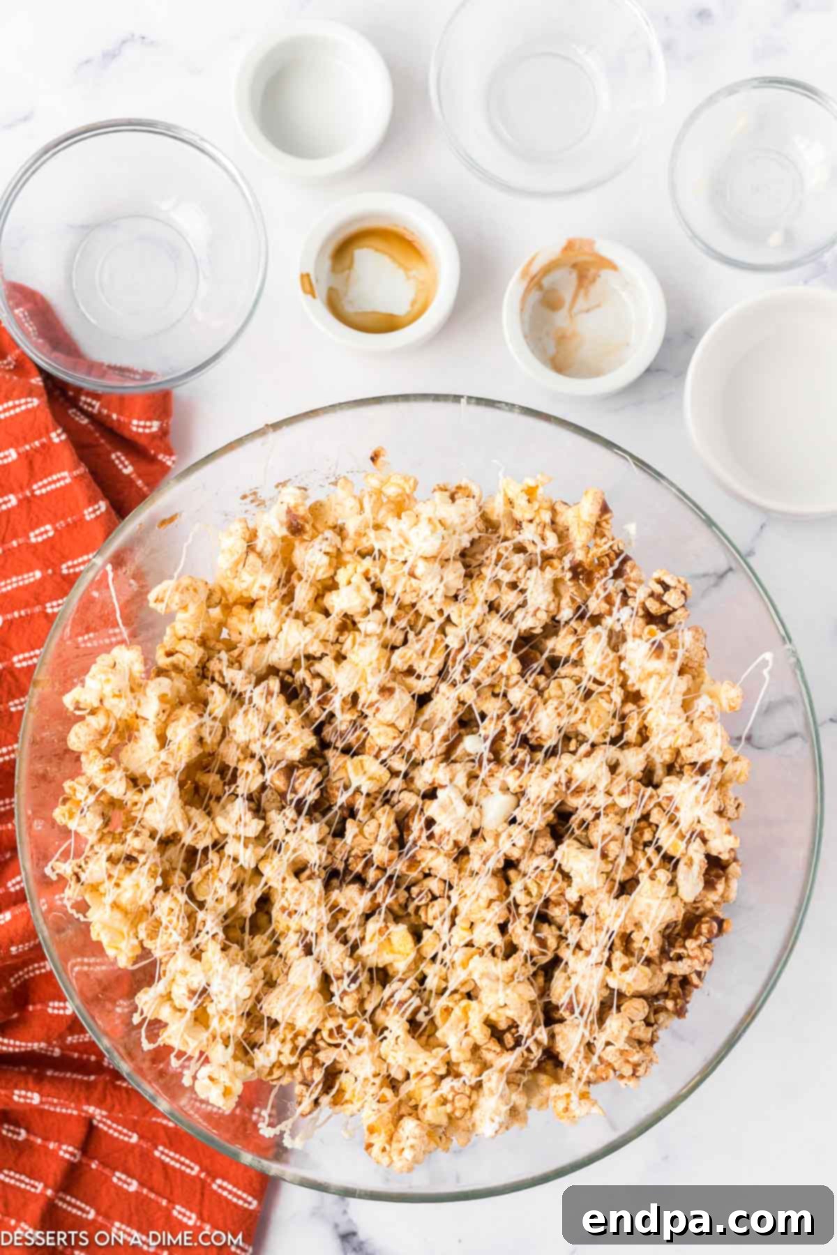 Frosted Cinnamon Popcorn 6 Melted white chocolate drizzled over popcorn.