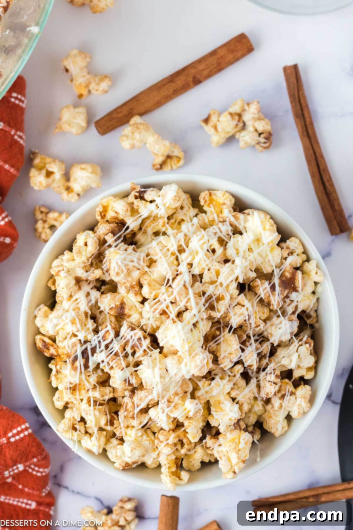 Frosted Cinnamon Popcorn 7 Cinnamon roll popcorn in a bowl.