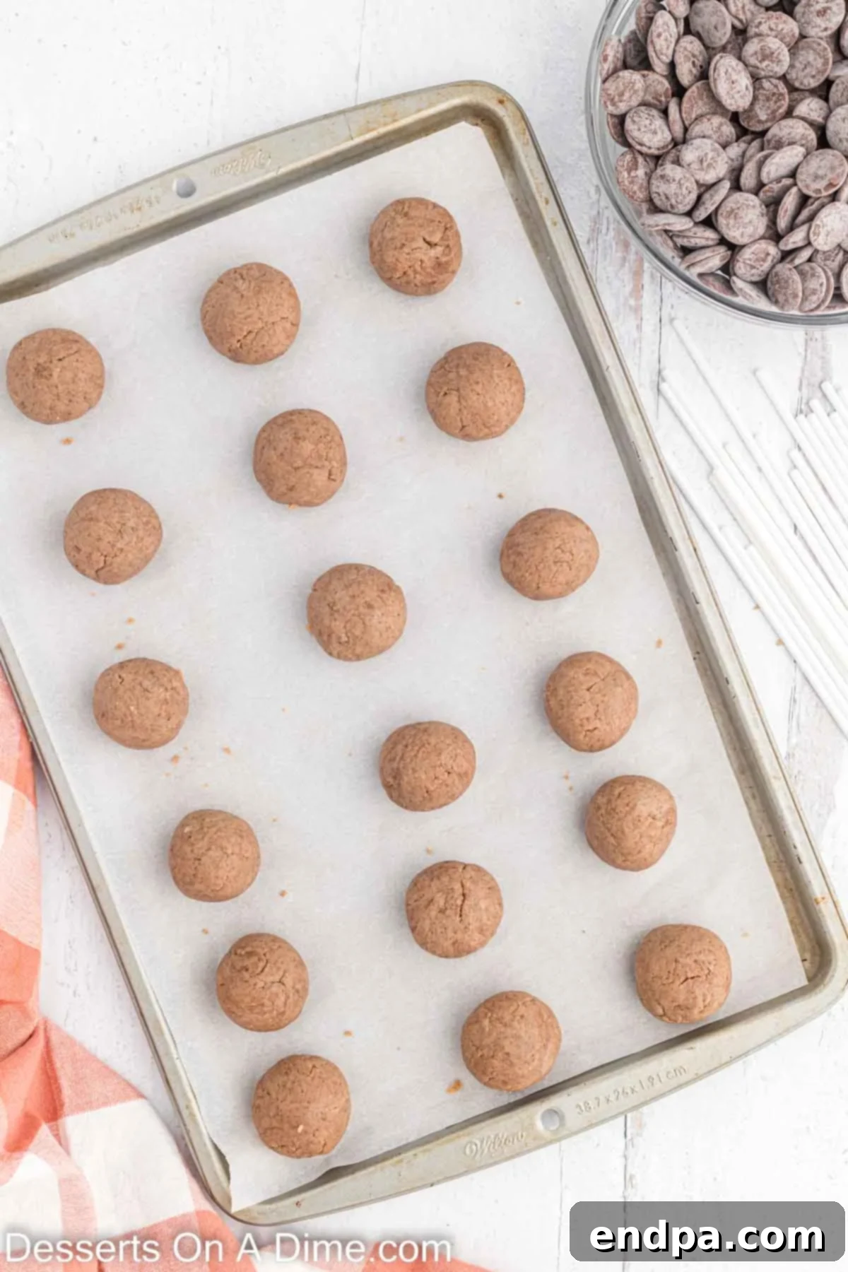 Cookie dough scooped into balls and placed on a baking sheet.