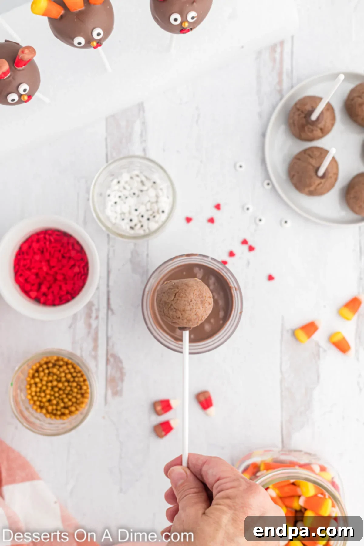 Cake pops dipped into chocolate.