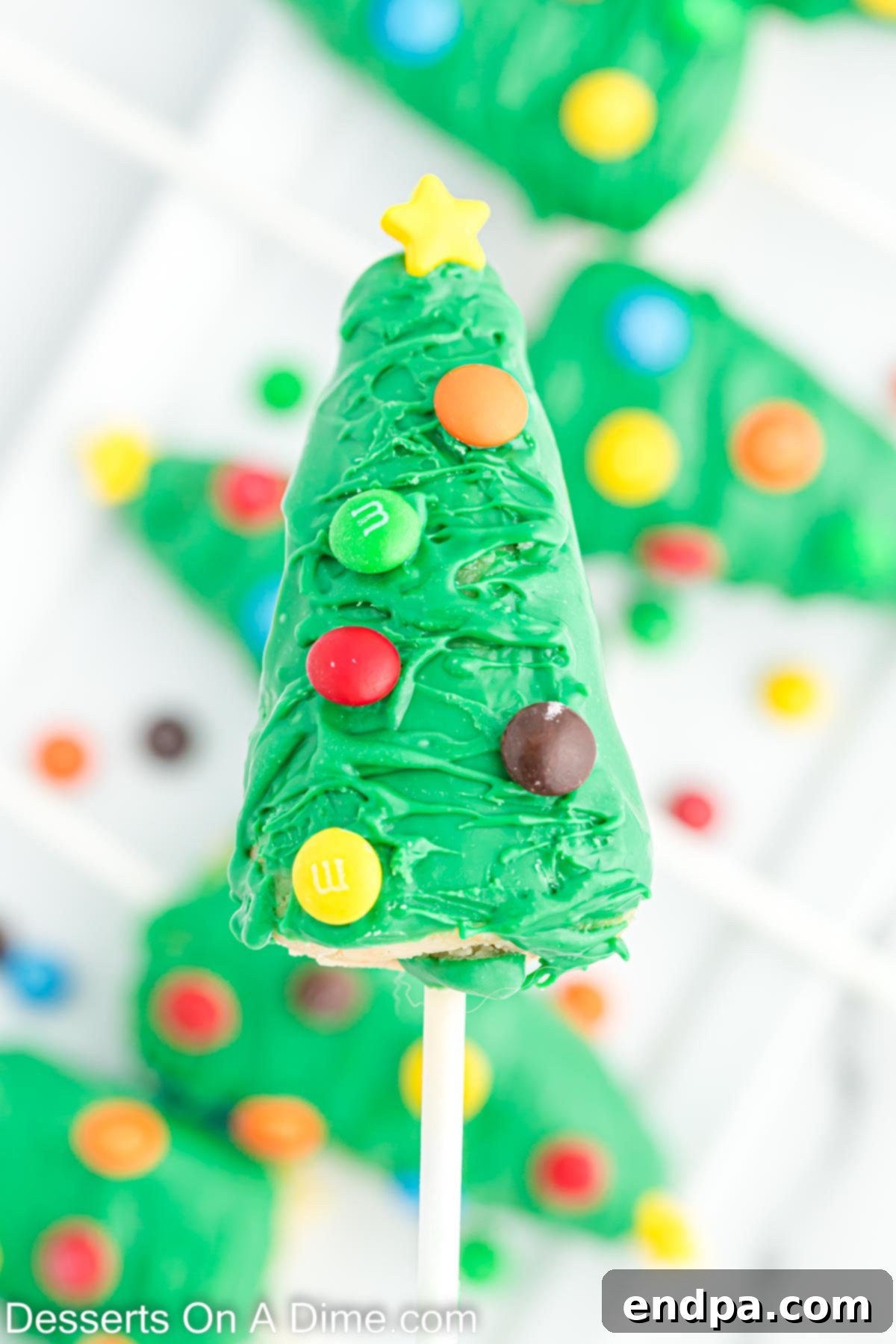 Close-up of a perfectly decorated Christmas Tree Cake Pop.
