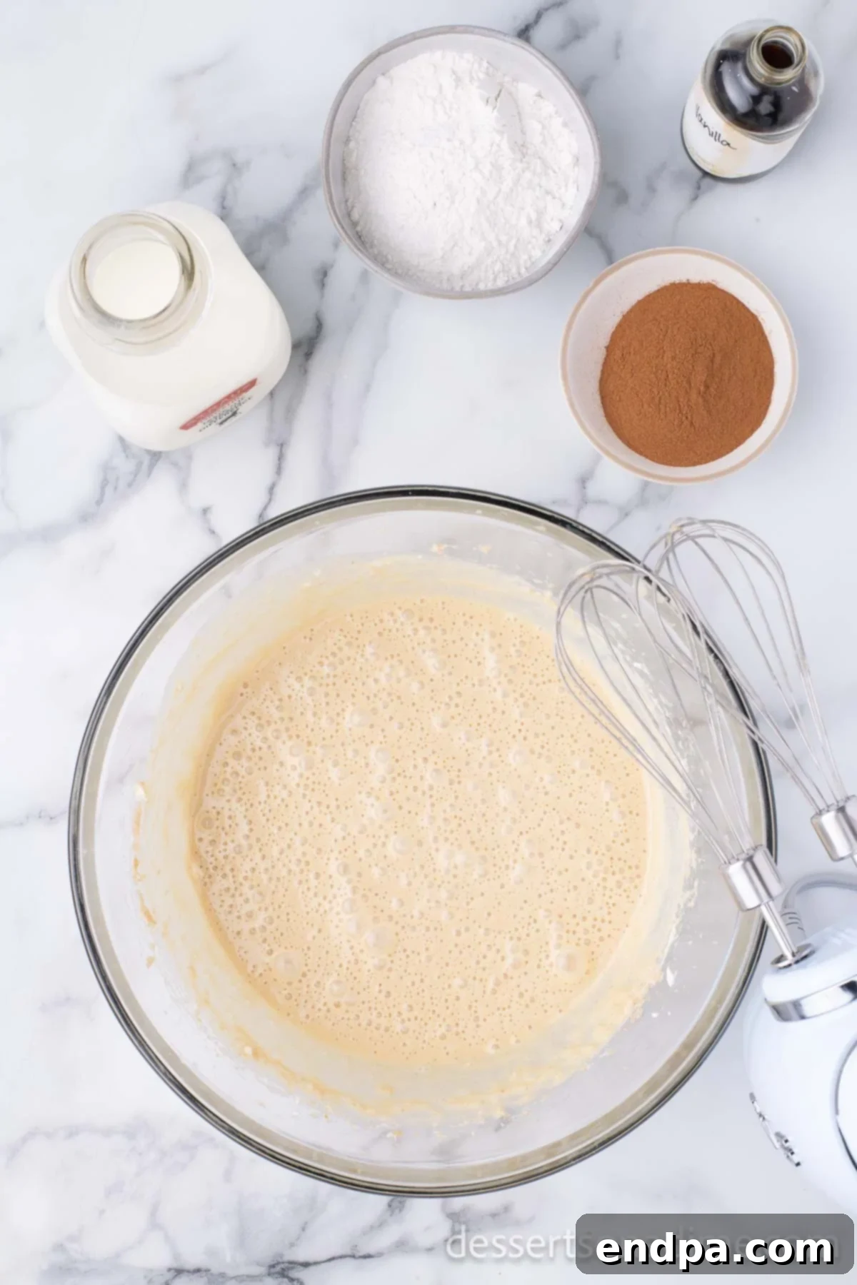 The smooth, creamy filling mixture for the cinnamon pie is thoroughly combined in a large mixing bowl, showing a uniform consistency.