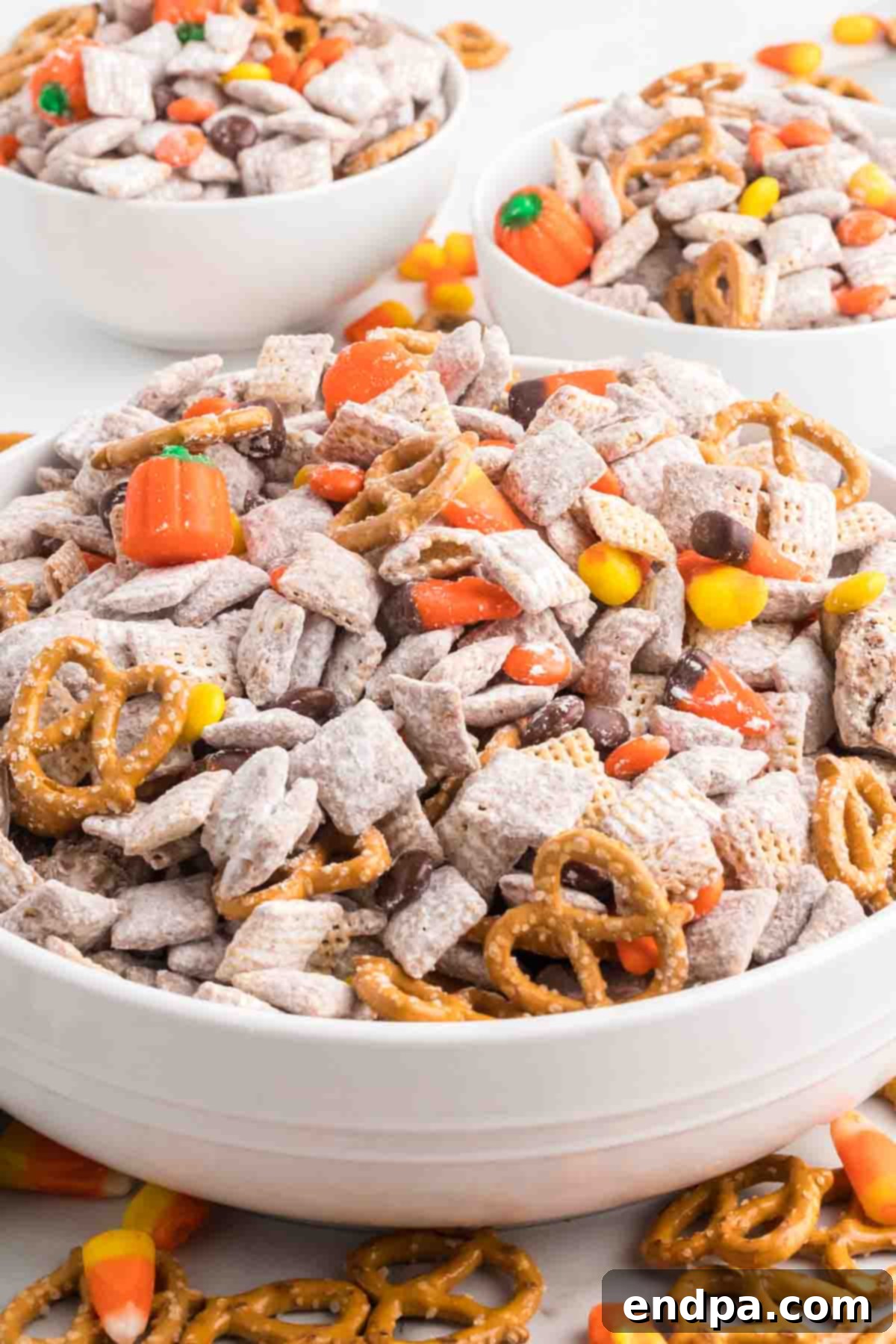 A bowl of vibrant Harvest Puppy Chow with autumn-colored candies, ready to be enjoyed.