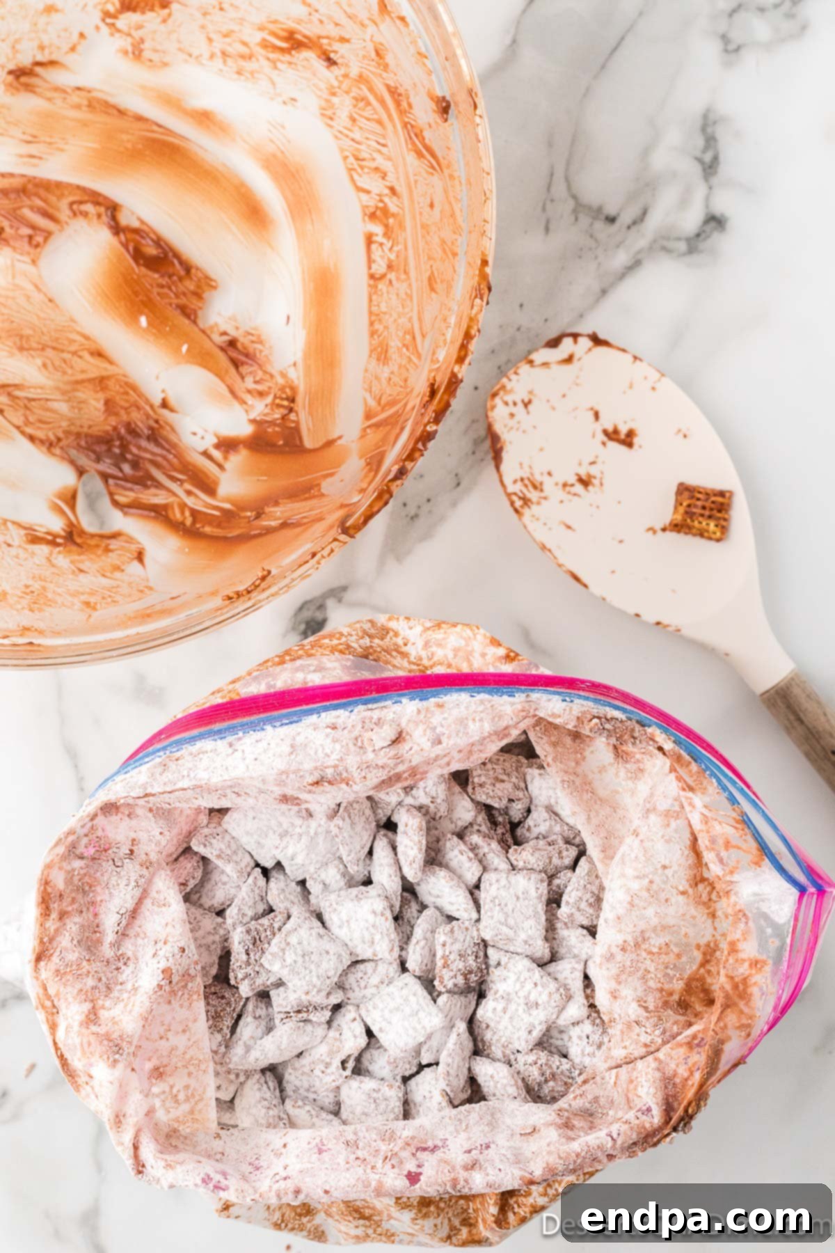Sealed Ziploc bag with chocolate-coated Chex cereal and powdered sugar being shaken to combine.