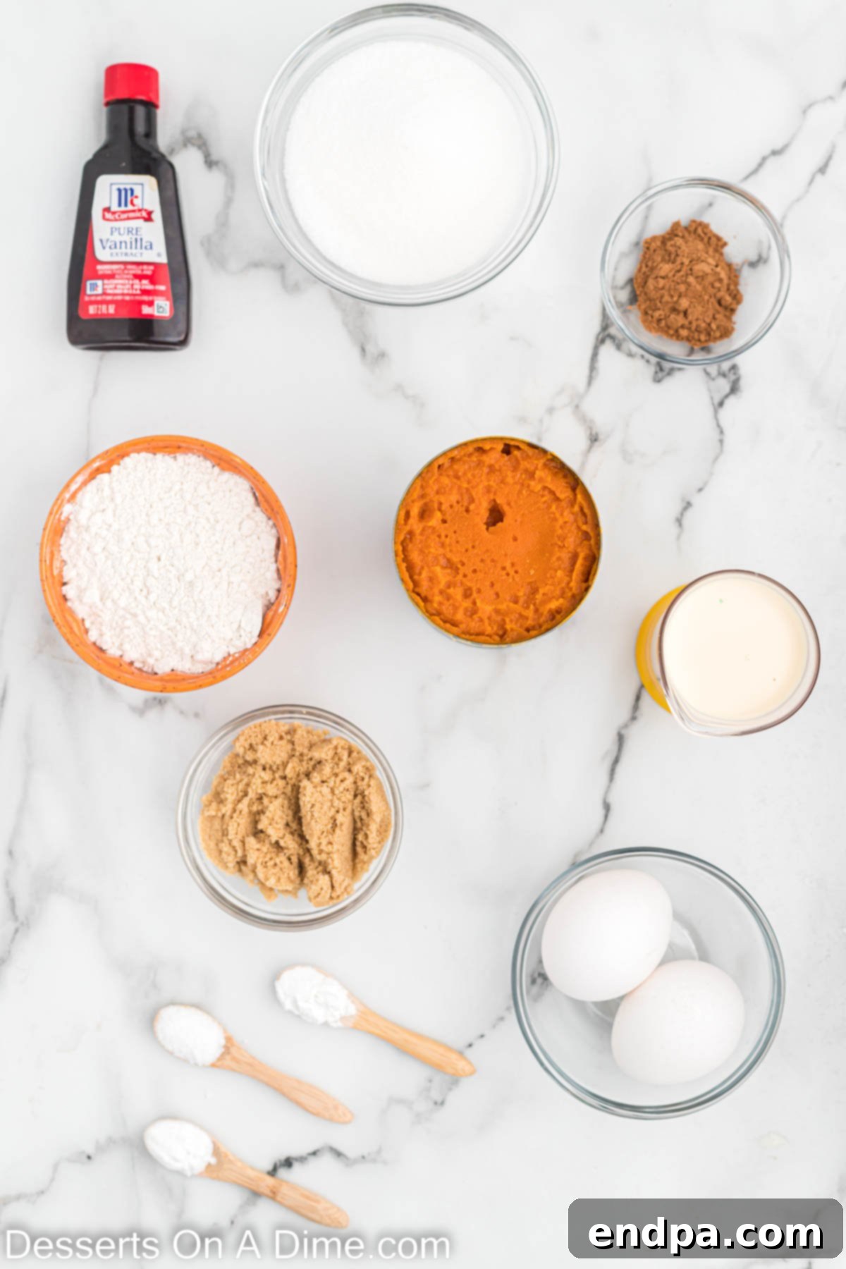 Ingredients for Pumpkin pie cupcakes including pumpkin puree, granulated sugar, brown sugar, eggs, vanilla extract, evaporated milk, all-purpose flour, pumpkin pie spice, salt, baking soda, baking powder, and whipped cream.