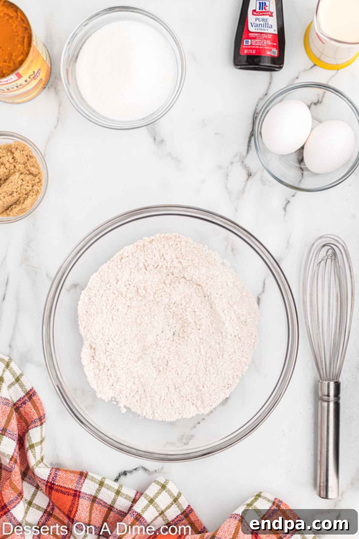 Combine dry ingredients in a bowl: flour, pumpkin spice, salt, baking soda, and baking powder.