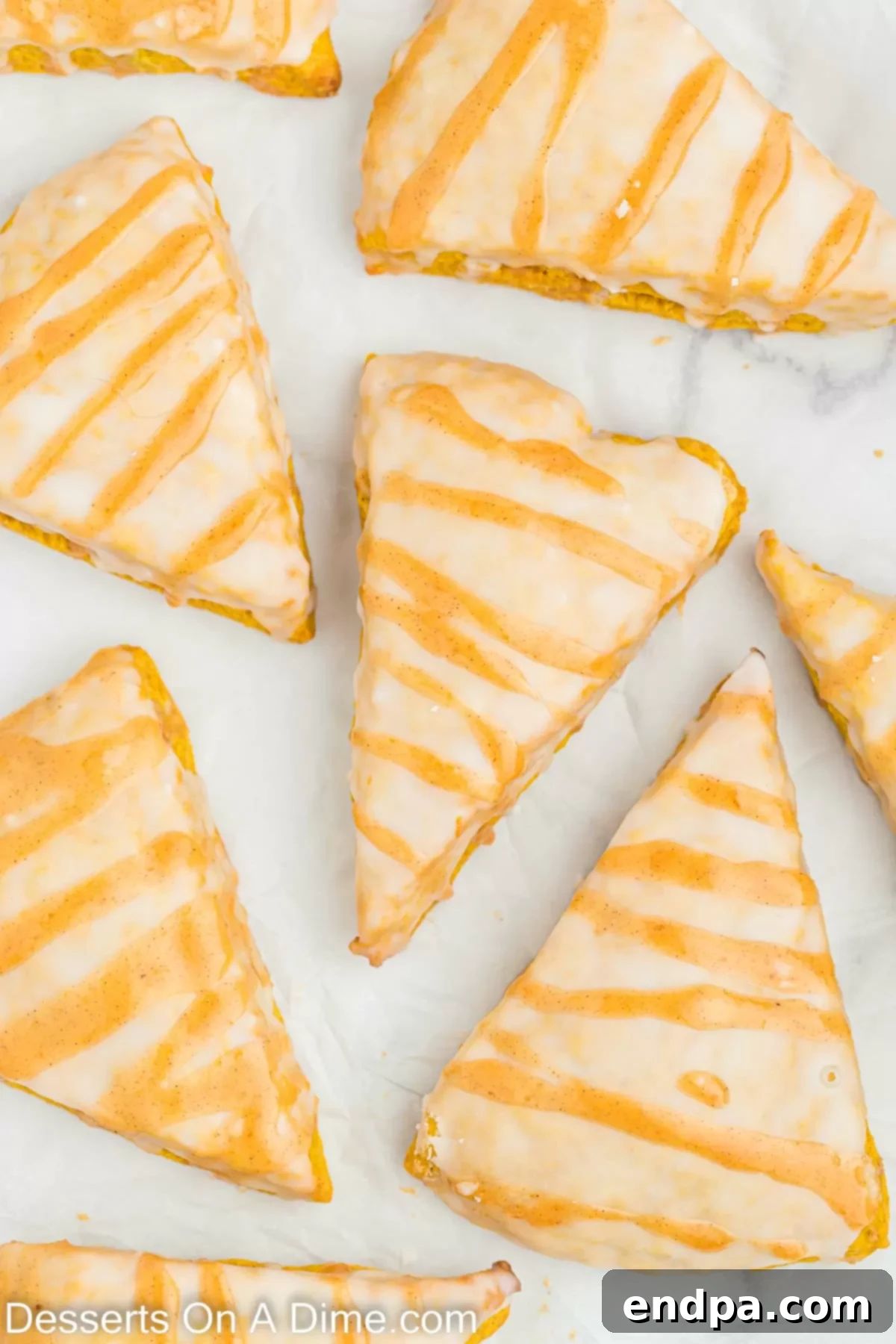 Beautifully glazed Starbucks pumpkin scones, garnished and ready to be served, showcasing the double glaze.