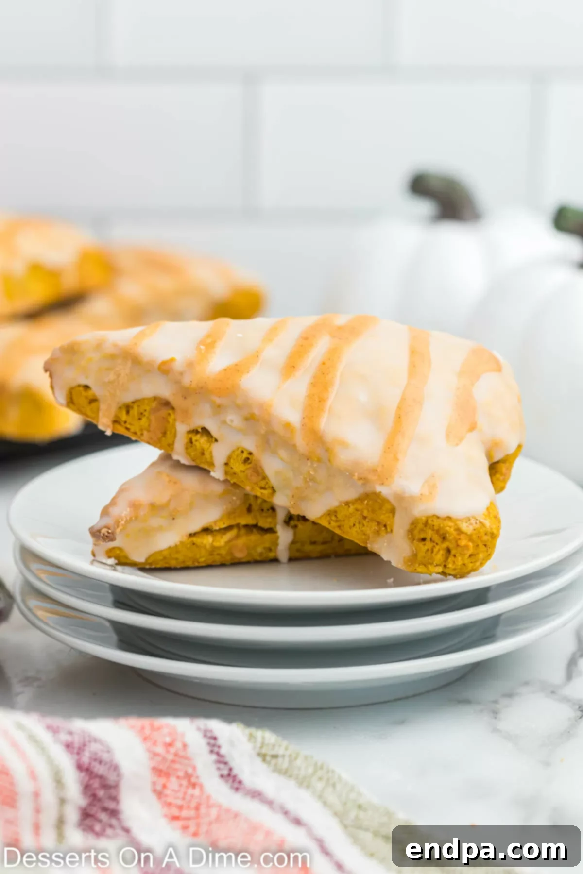 A delightful presentation of Starbucks pumpkin scones on a plate, featuring the double glaze and ready to be enjoyed as a perfect fall treat.