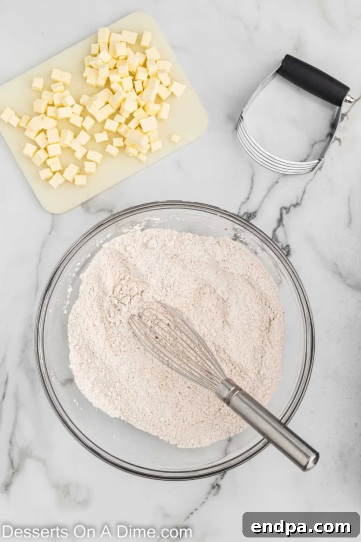 Dry ingredients for pumpkin scones, including flour, baking powder, baking soda, pumpkin pie spice, salt, and brown sugar, perfectly combined in a large mixing bowl.