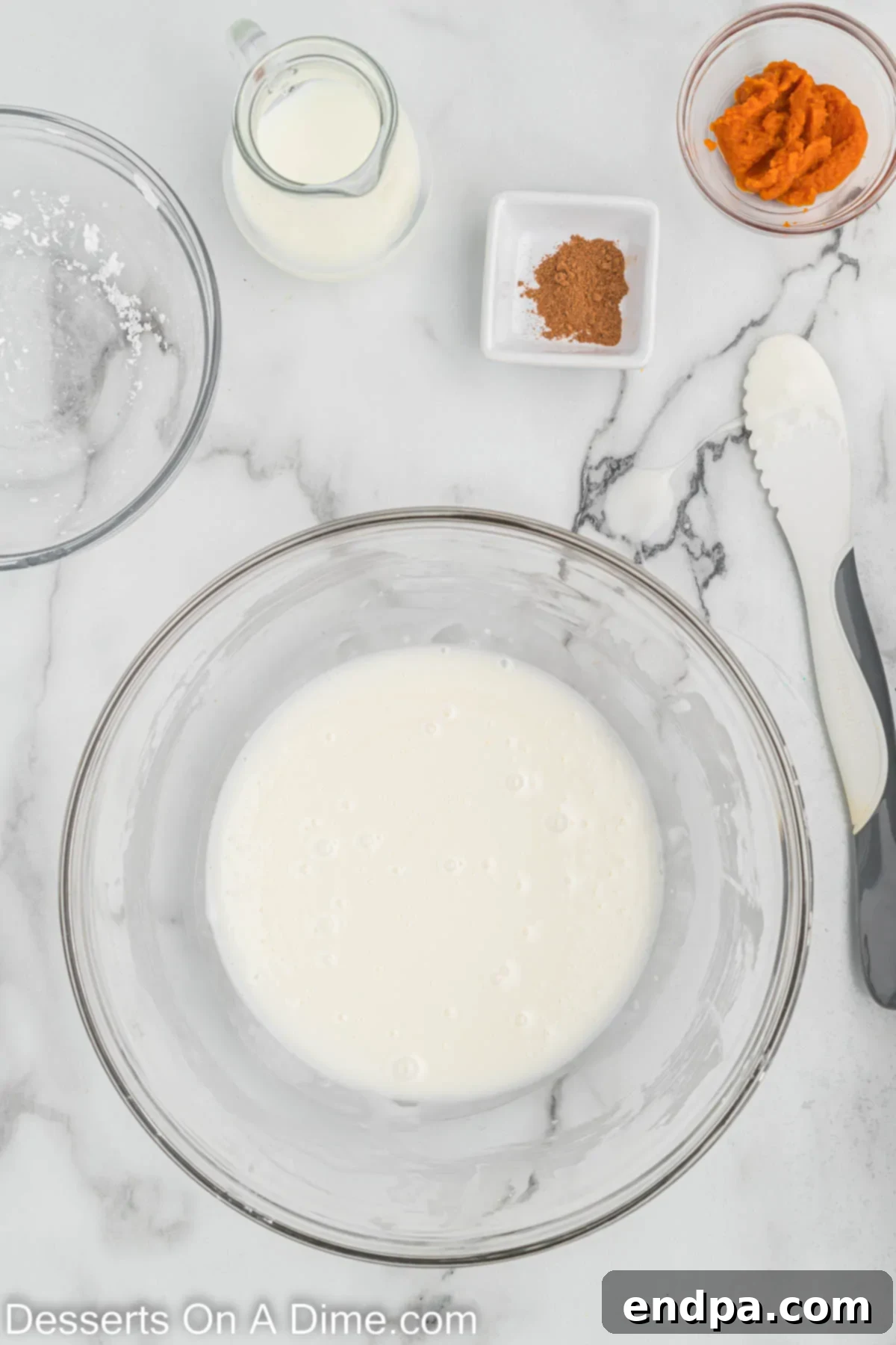 Powdered sugar and milk being whisked together in a bowl to create the base for the scone glazes.