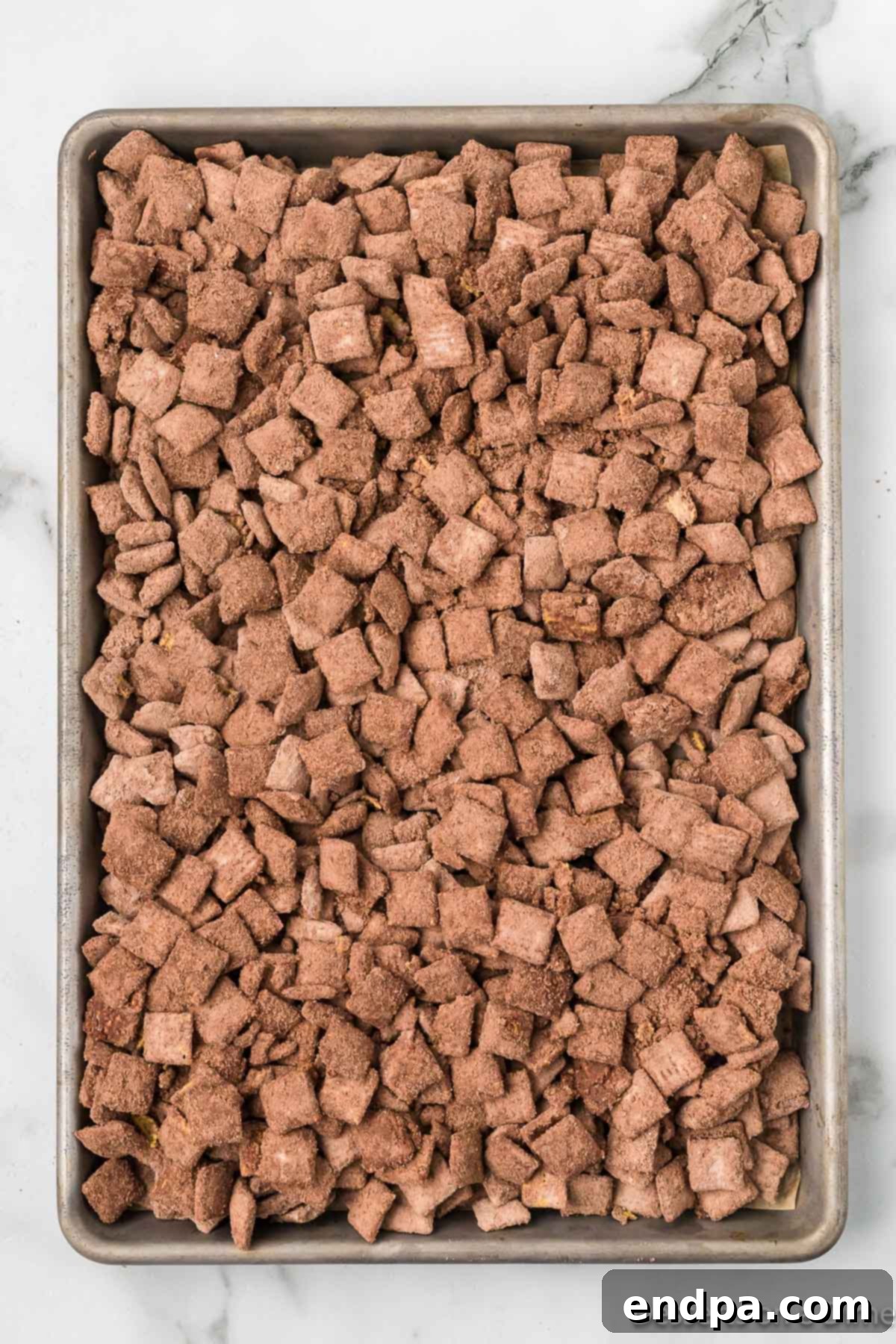 Double Fudge Brownie Crunch 10 Cereal spread out on baking sheet.