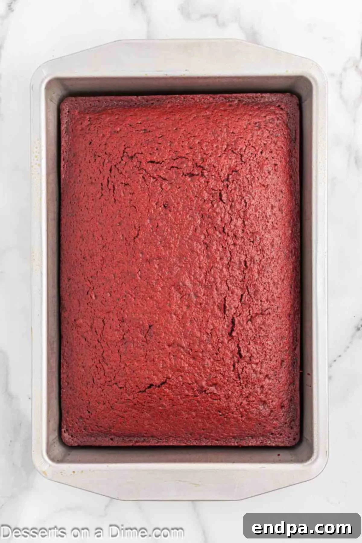 Red velvet cake cooling in pan.