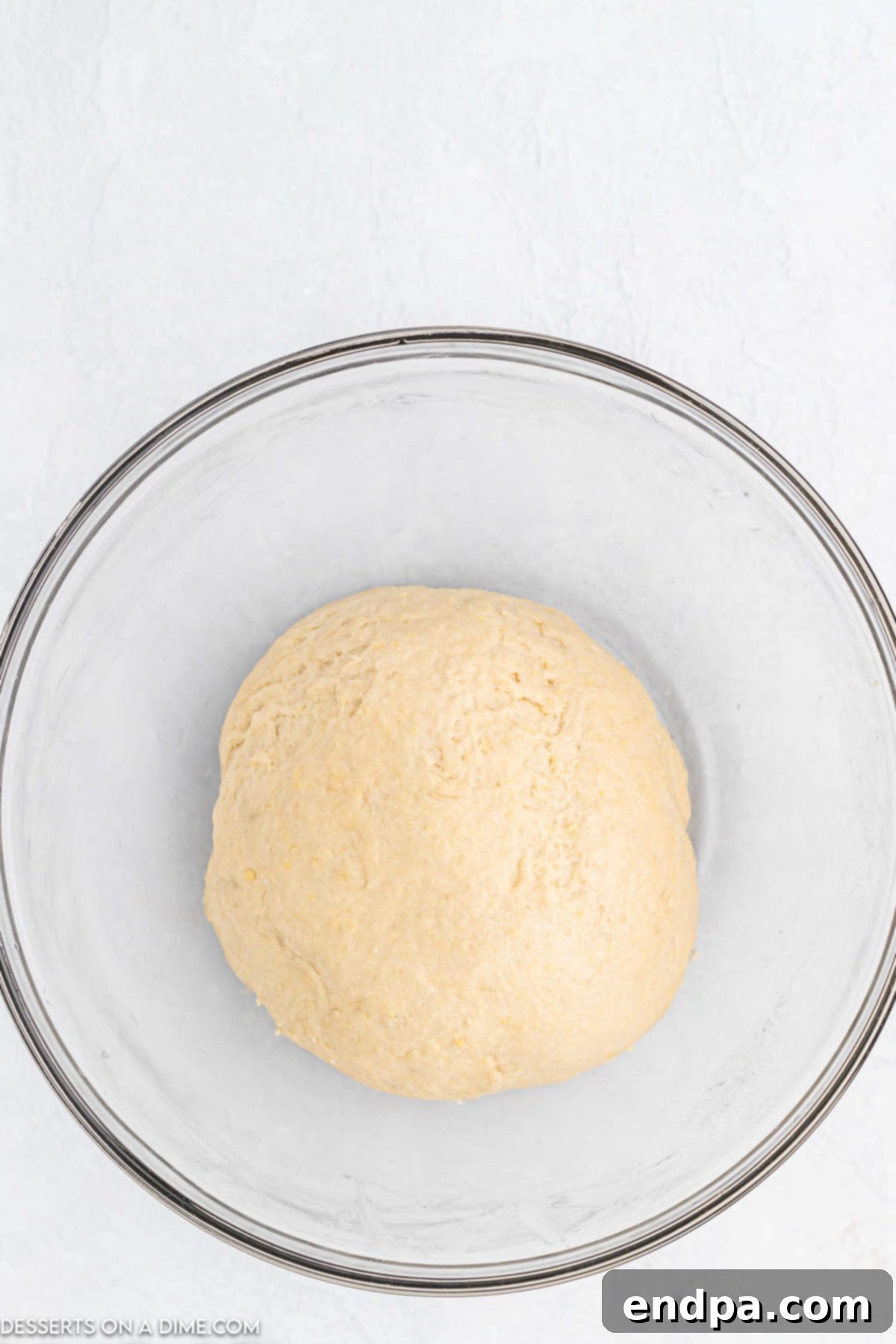 Crafting Perfect Cinnabon Cinnamon Rolls 5 Dough ingredients being combined in a stand mixer bowl with a dough hook attachment.