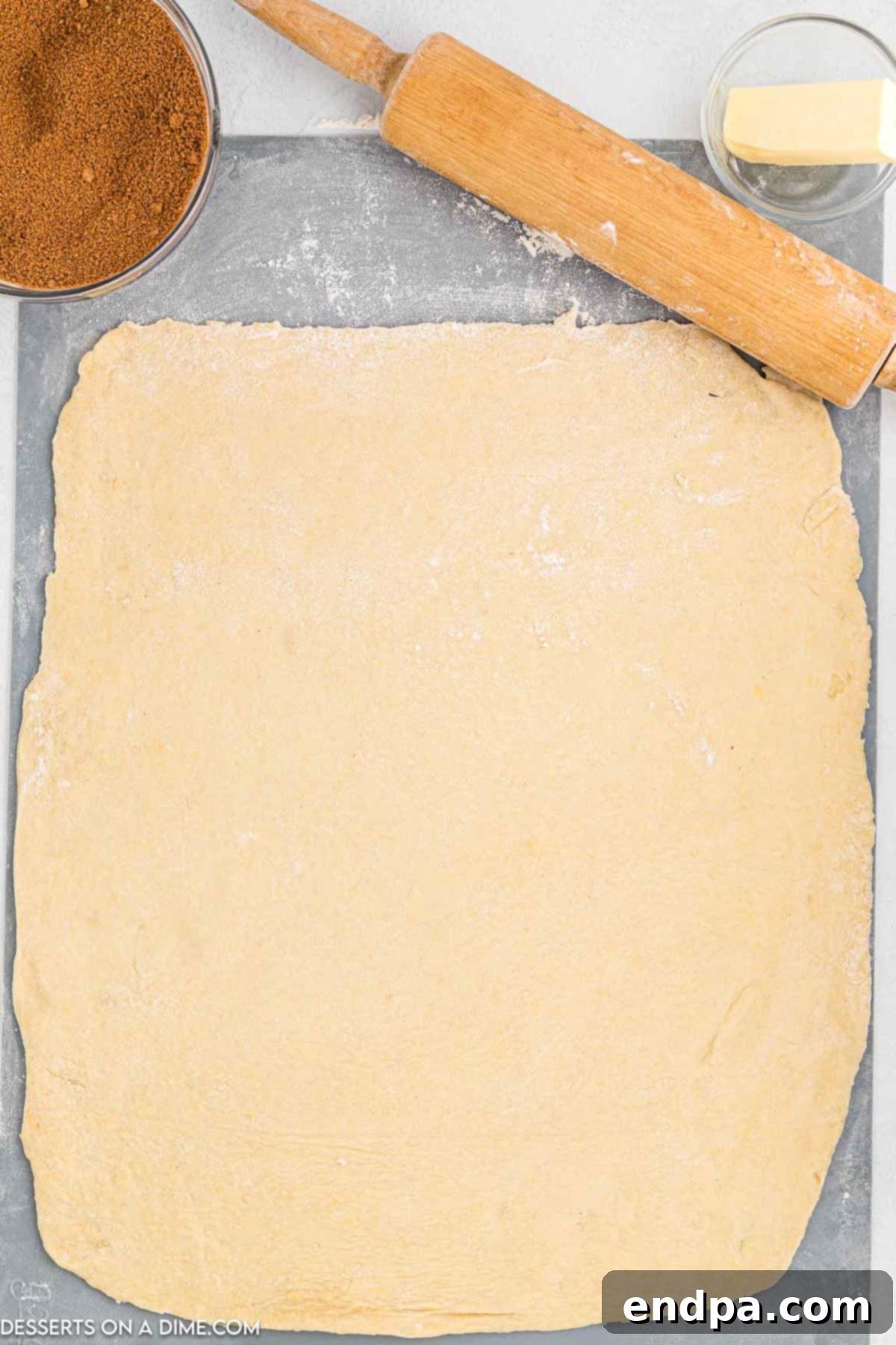 Crafting Perfect Cinnabon Cinnamon Rolls 7 Soft cinnamon roll dough rolled out into a large rectangle on a lightly floured surface.