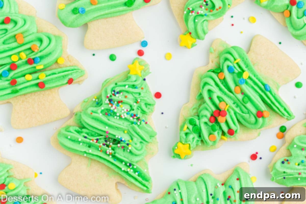 Holiday Tree Sugar Cookie Delights 2 Beautifully decorated Christmas tree sugar cookies with green icing and colorful sprinkles, arranged together for a festive display.