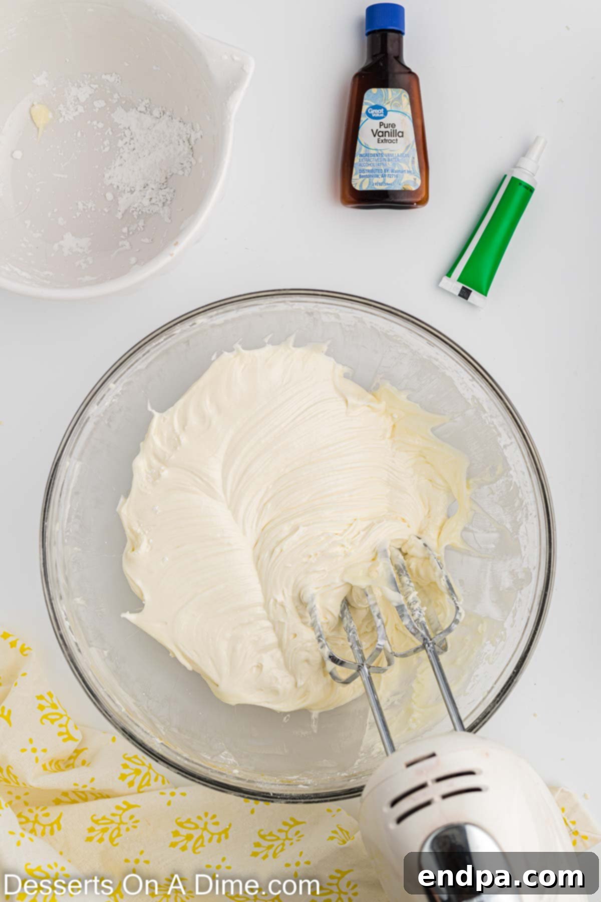 Holiday Tree Sugar Cookie Delights 9 Powdered sugar being gradually added to the cream cheese and butter mixture in a mixing bowl.