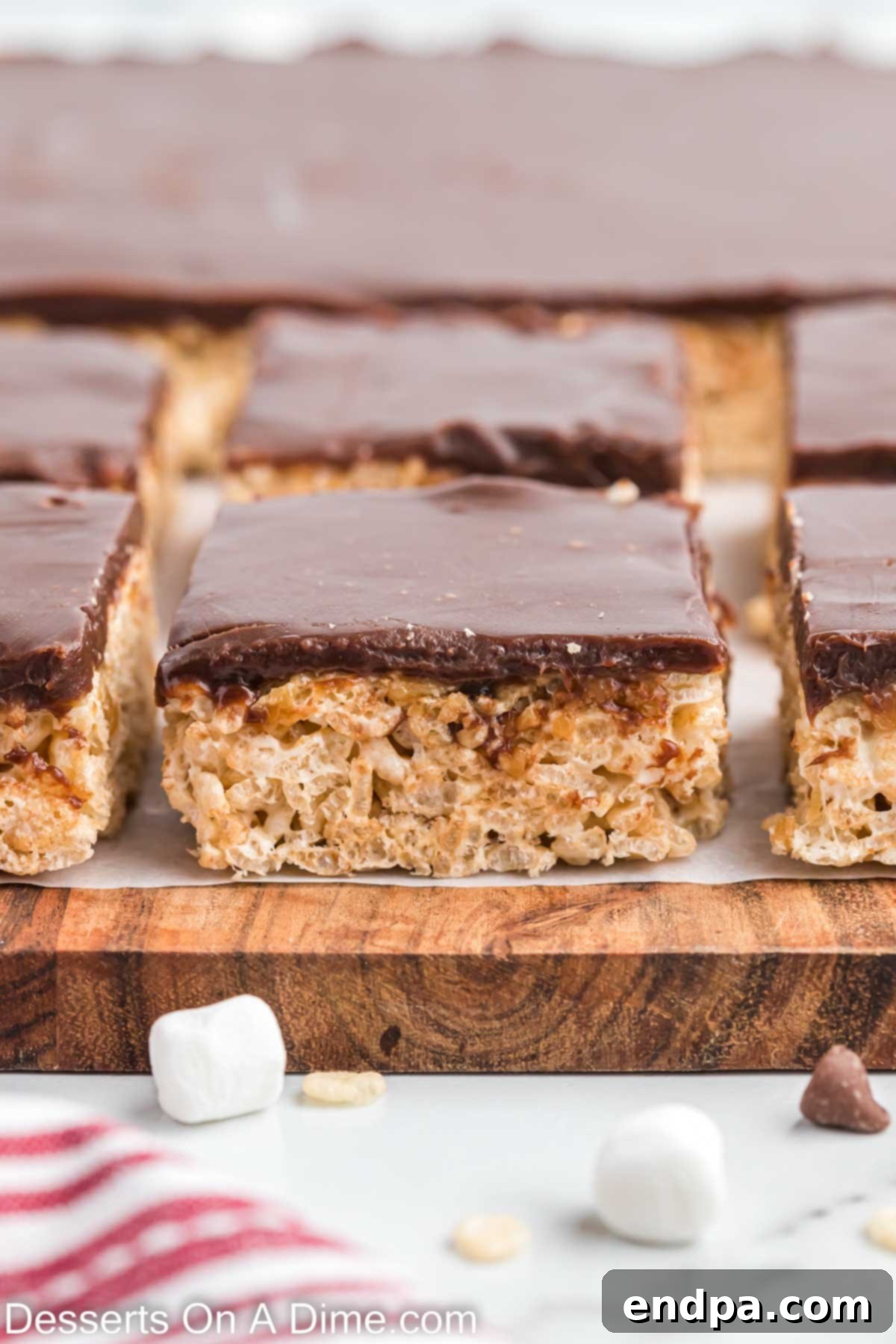Close-up of ready-to-enjoy Chocolate Caramel Rice Krispie Treats, showing the three distinct layers.