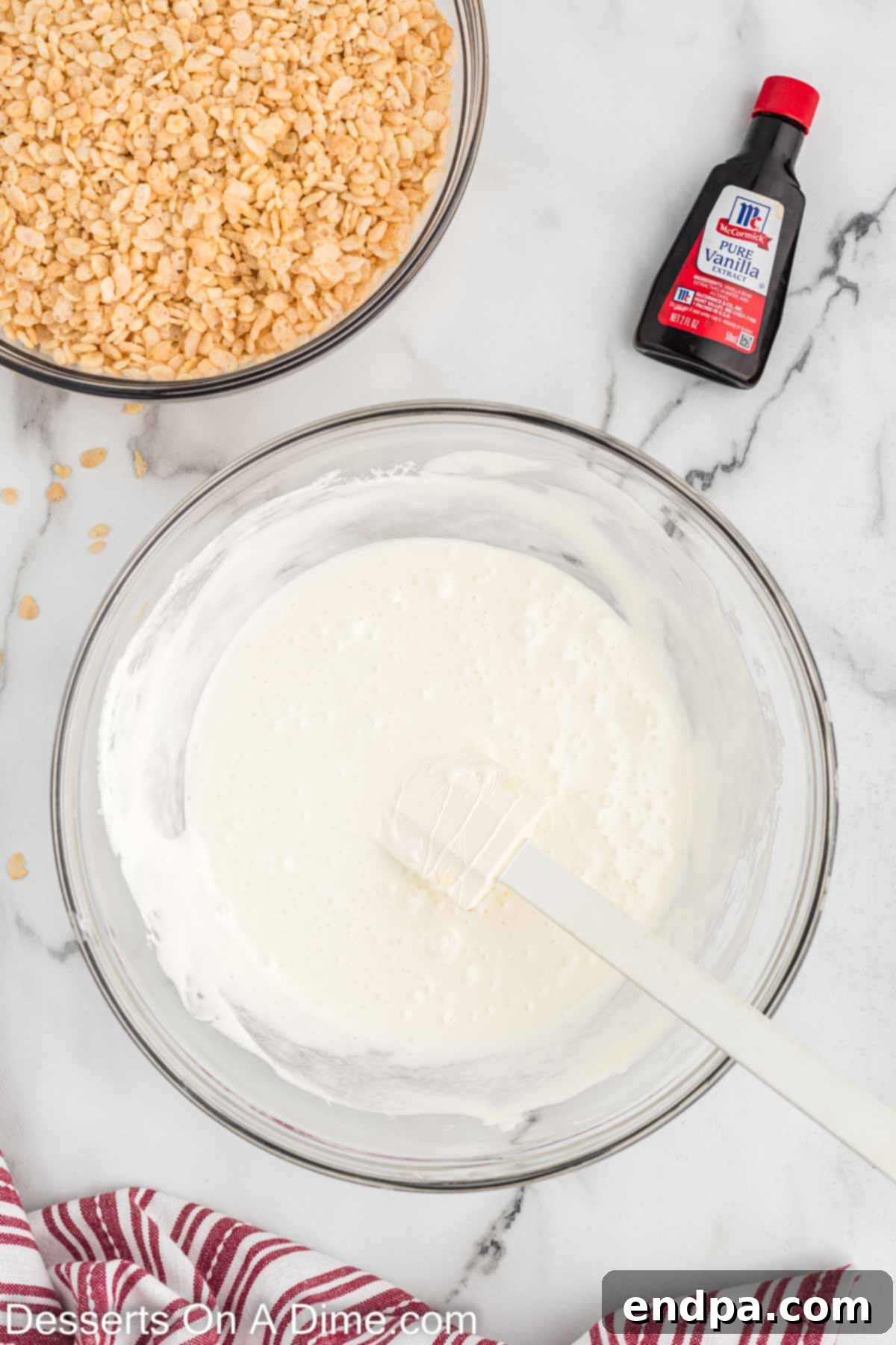 Bowl of melted butter and marshmallows for rice krispie treats.