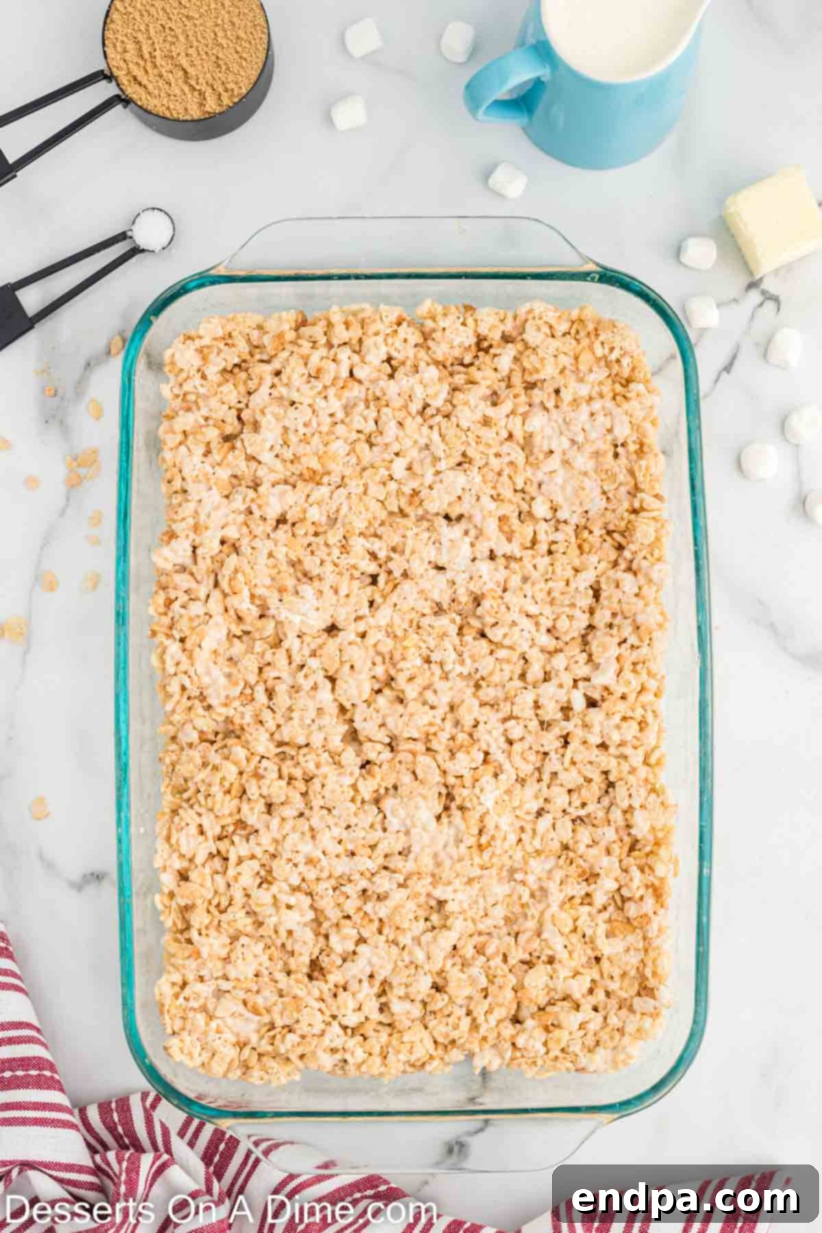 Cereal mixture pressed evenly into a 9x13 inch baking pan.