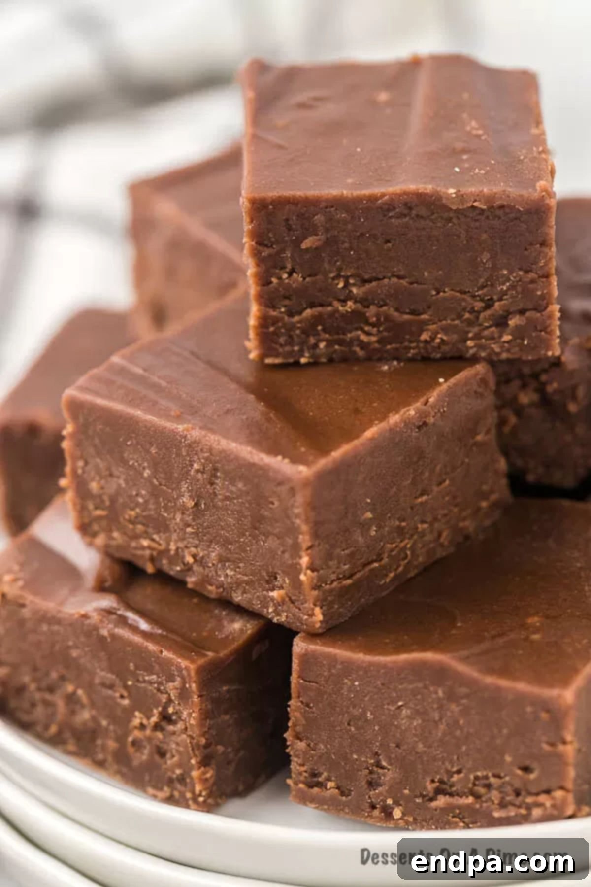 Chocolate Fudge pieces stacked together, glistening and ready for storage.