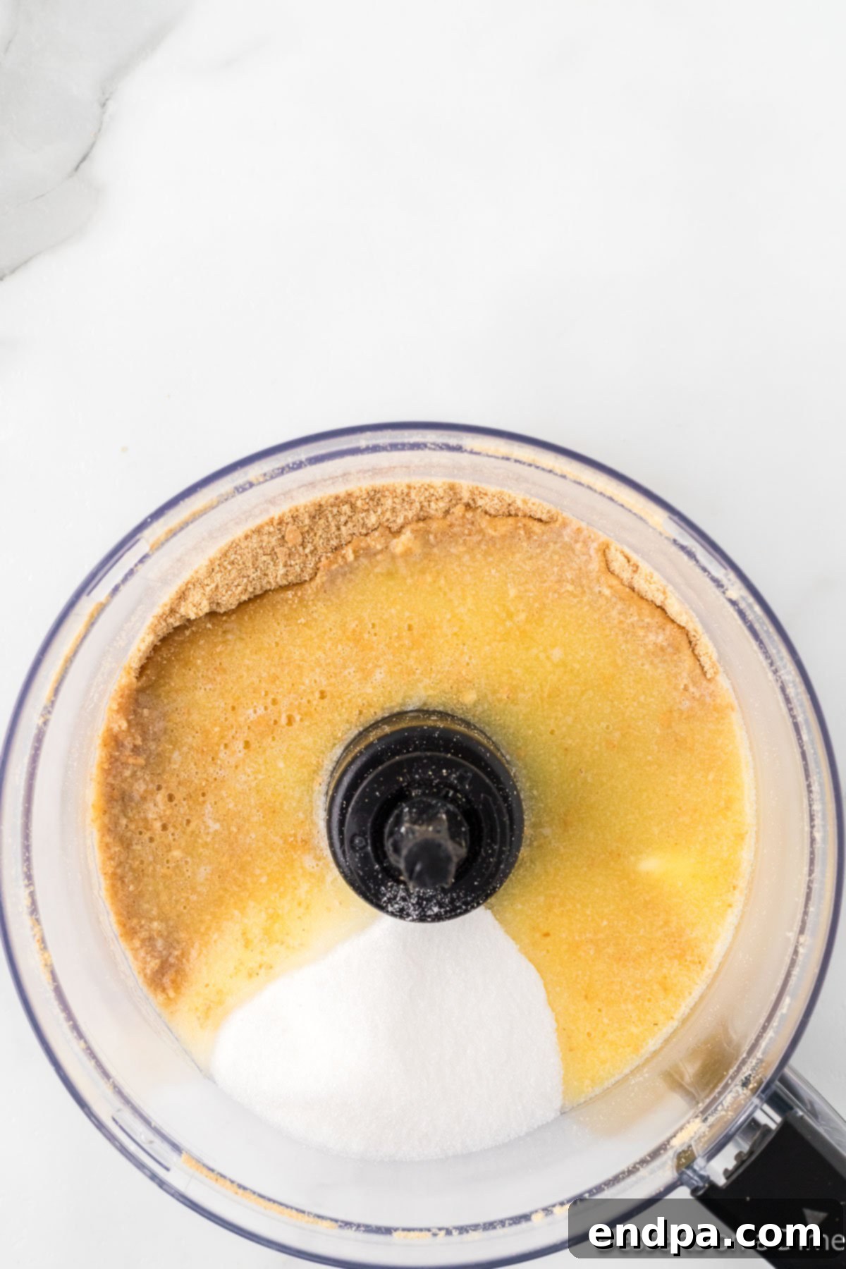Cool Lemon Cloud Pie 5 Sugar and salt being added to graham cracker crumbs in a food processor.