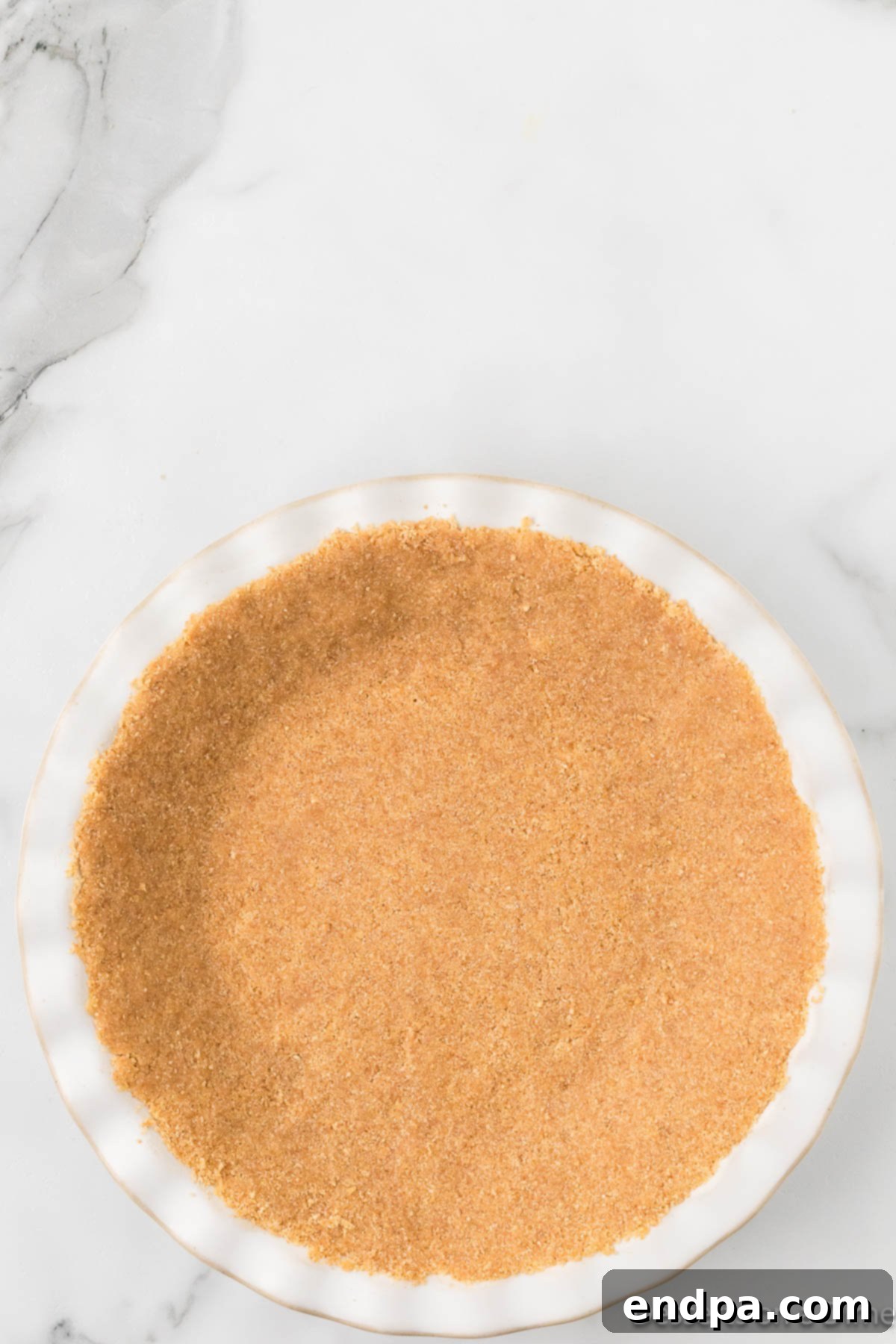 Cool Lemon Cloud Pie 6 Graham cracker mixture being pressed into a pie dish.