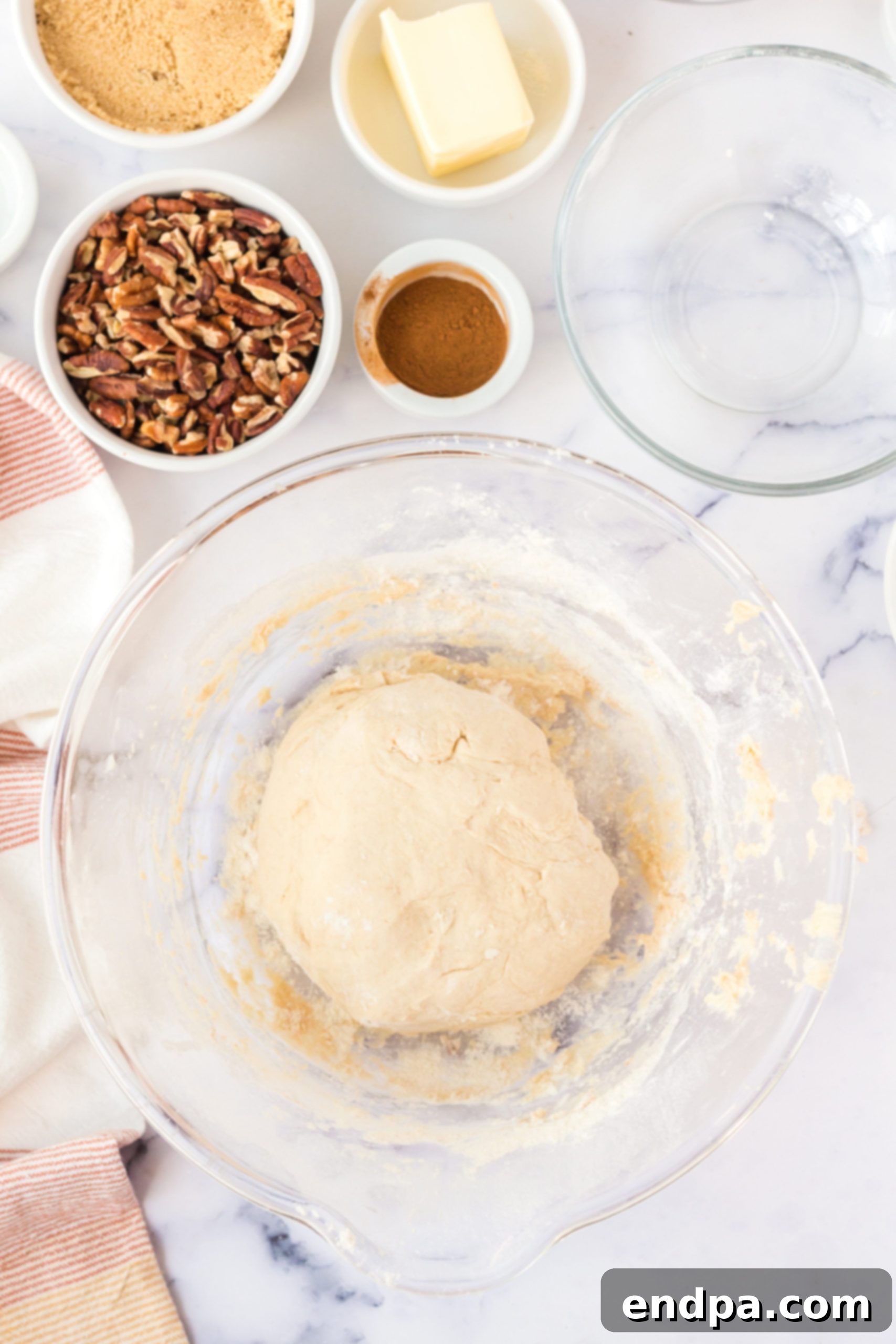 Smooth, elastic dough after kneading, resting in a bowl.