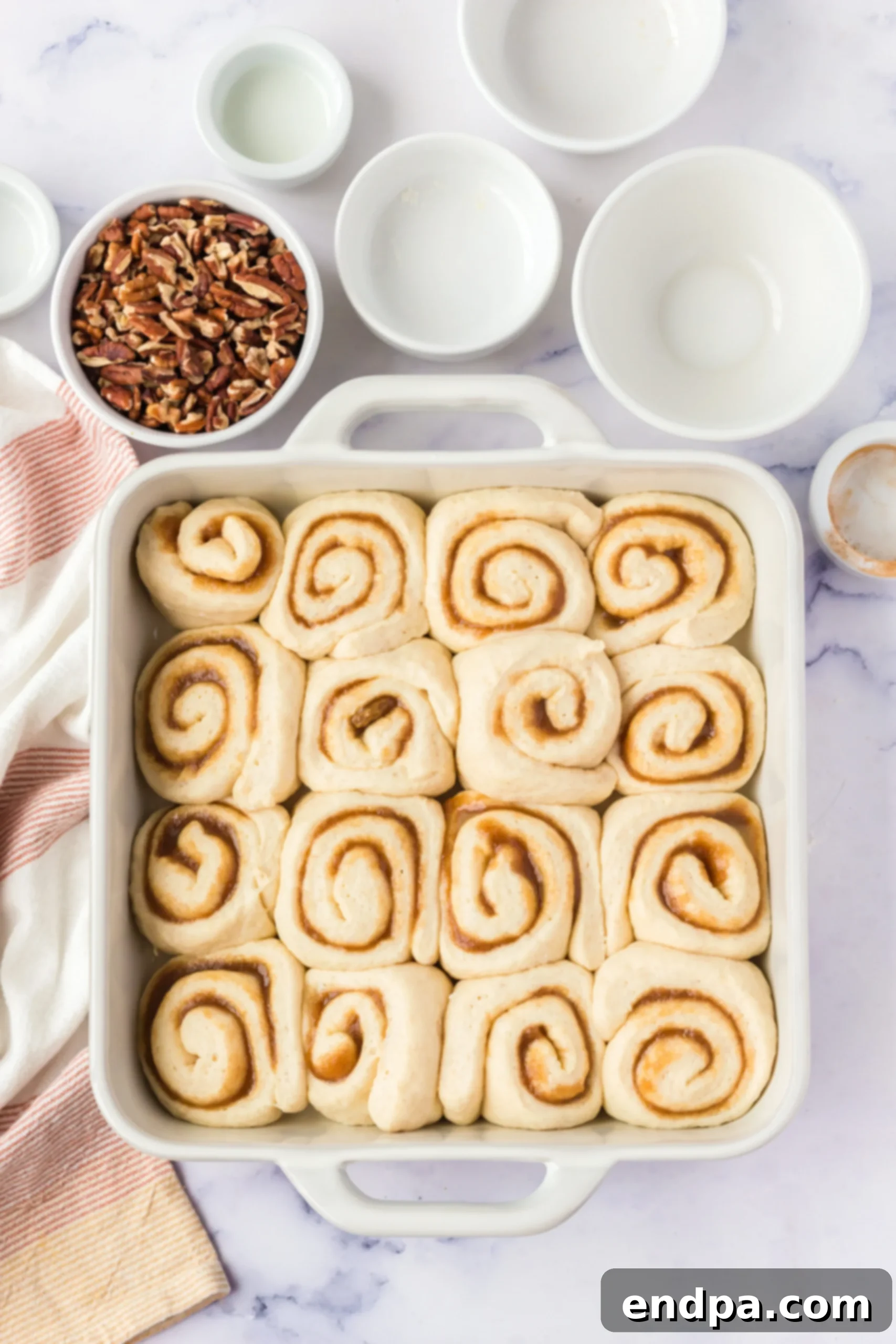 Cinnamon rolls arranged in a baking pan, golden brown and perfectly baked.
