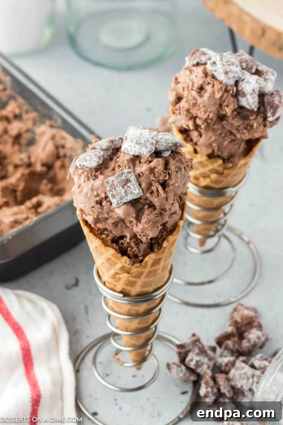 Muddy Munch Ice Cream 2 Puppy chow ice cream in cones, showcasing its rich texture and mixed-in ingredients.