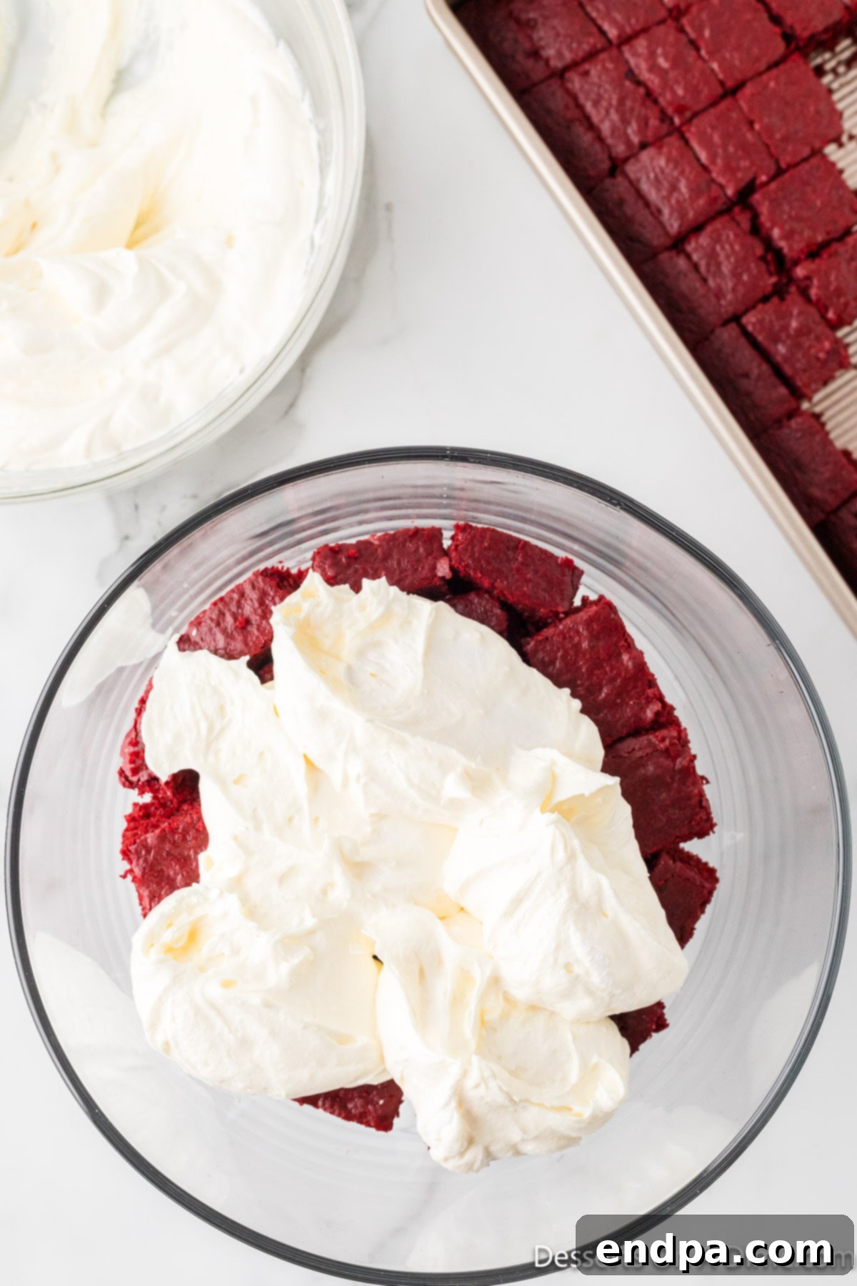 Crimson Velvet Dream 13 Cream cheese layer added on top of cake layer. The creamy white layer spread evenly over the red cake.