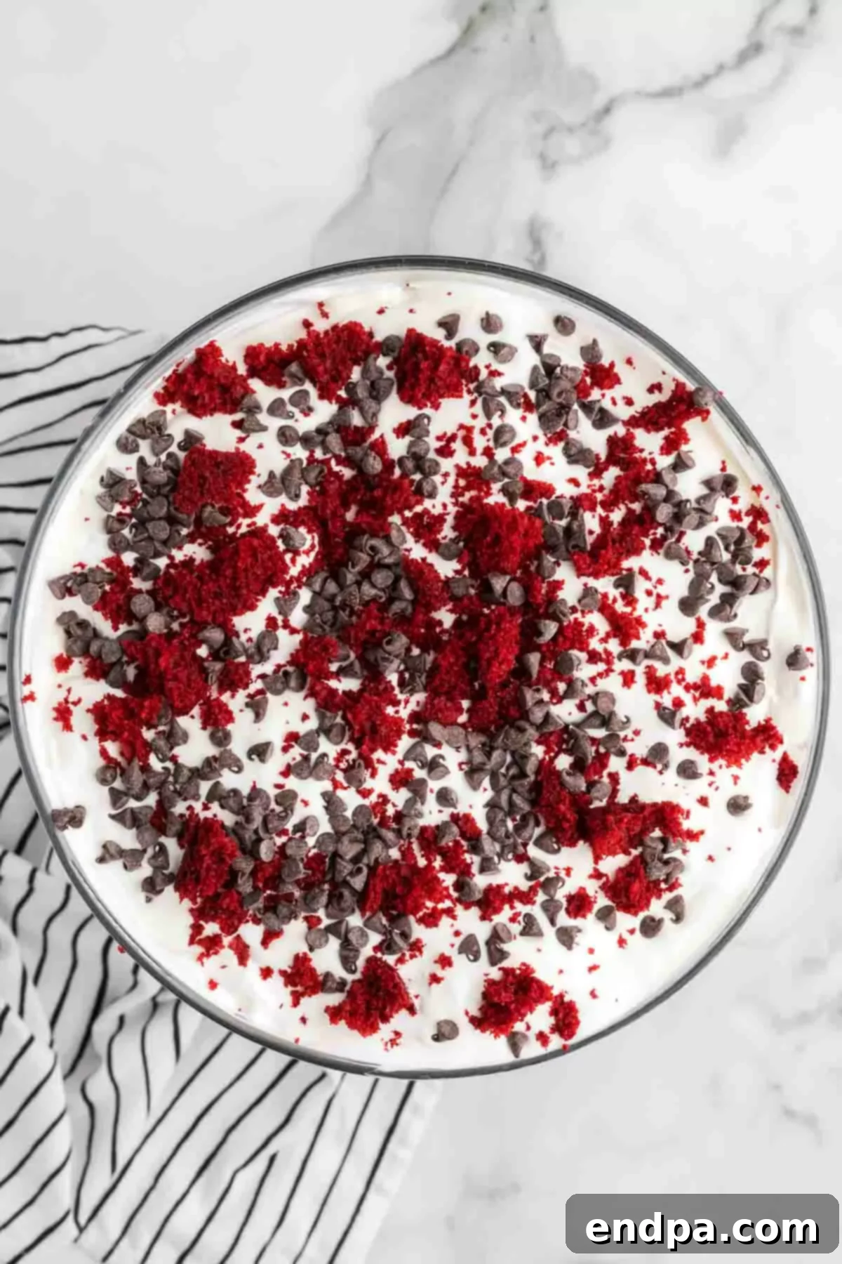 Crimson Velvet Dream 17 Cake crumbs and chocolate spread on top of cake. The finished trifle, garnished and ready to serve.