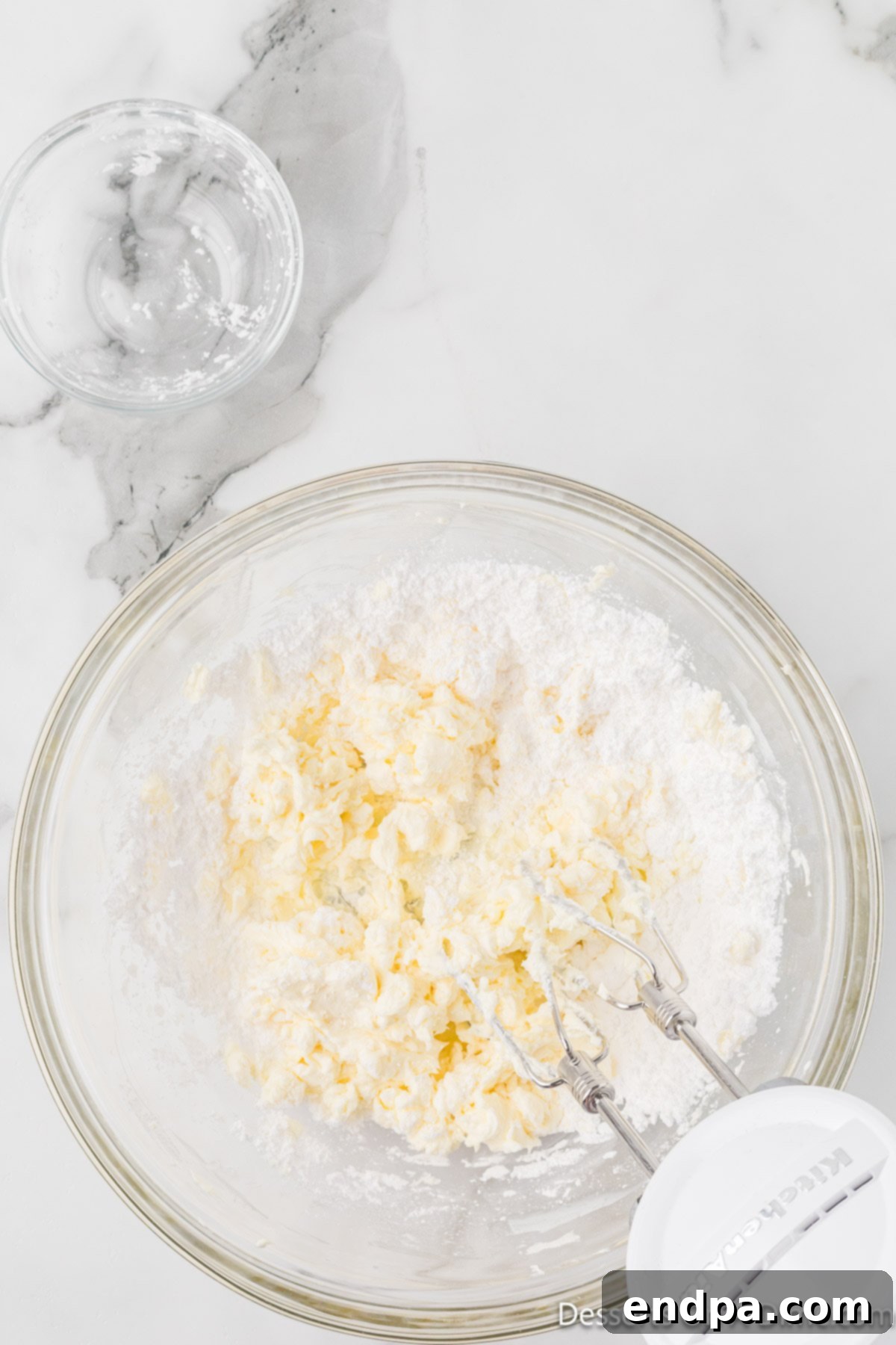 Crimson Velvet Dream 9 Powdered sugar gradually added. Fine powdered sugar being incorporated into the cream cheese.