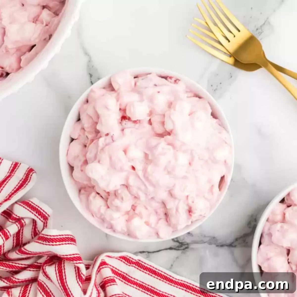 A bowl of Cherry Fluff, showcasing its texture and vibrant color. 