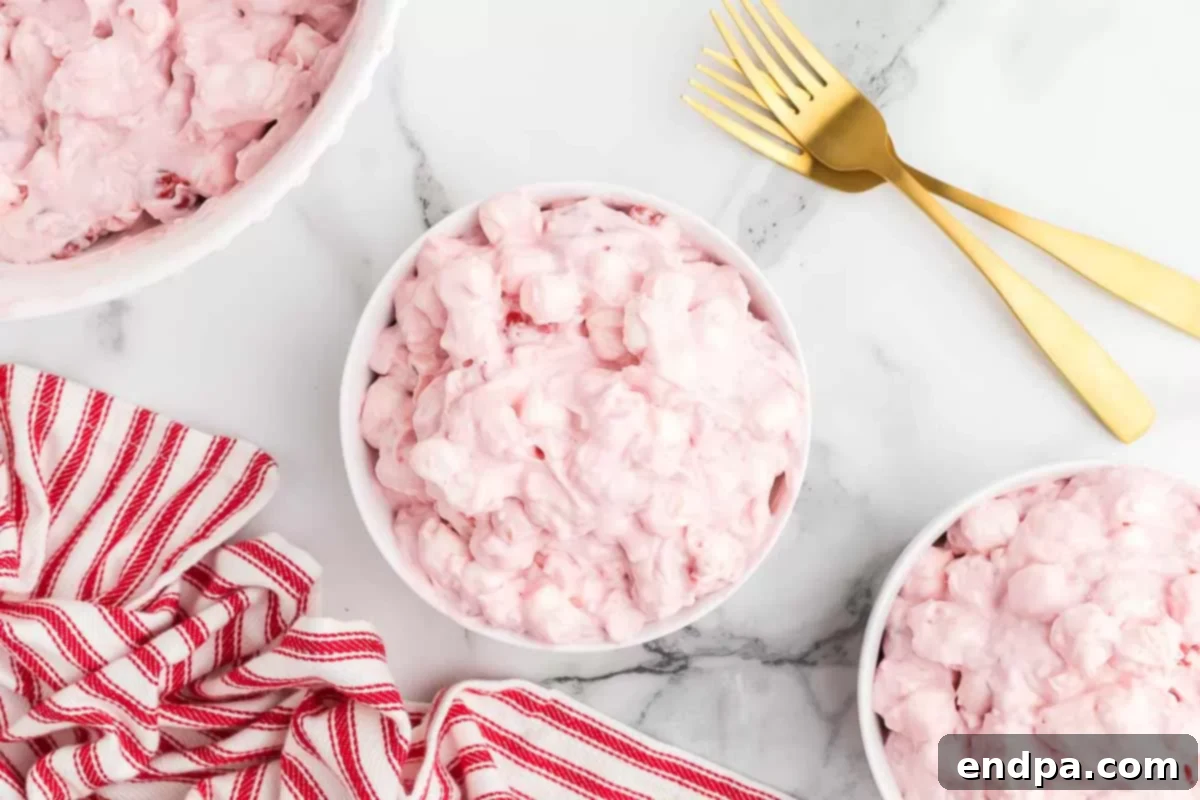 A close-up of the Cherry Fluff recipe in a bowl, highlighting the marshmallows and creamy texture. 